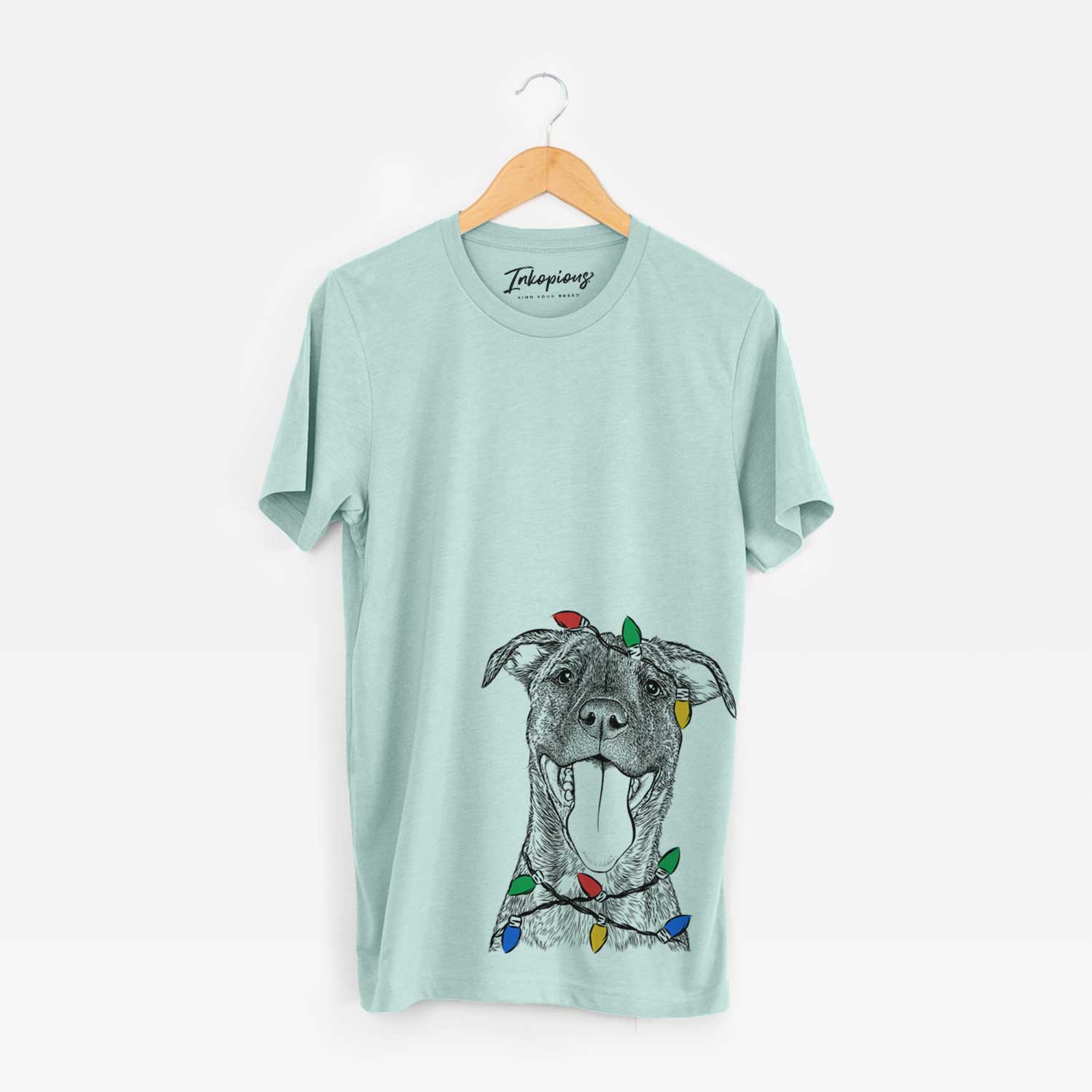 Hand-drawn sketch of Harley the Pitbull Mix wrapped in Christmas lights on a Heather Sage Unisex crewneck