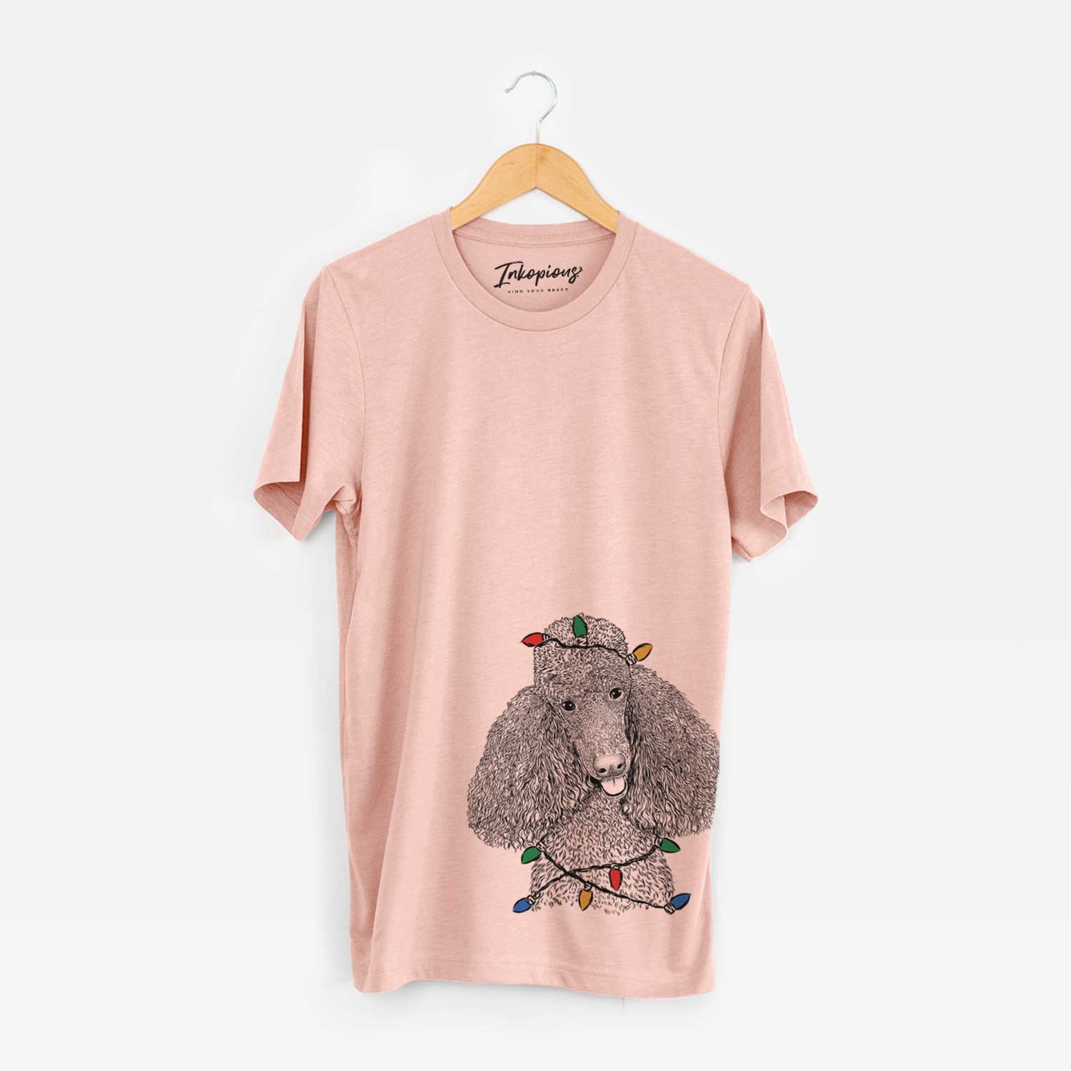 Hand-drawn sketch of Henry the Standard Poodle wrapped in Christmas lights on a Peach Unisex crewneck
