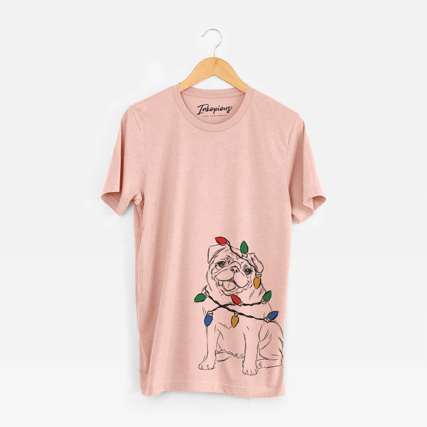 Hand-drawn sketch of Higgins the Pug wrapped in Christmas lights on a Peach Unisex crewneck