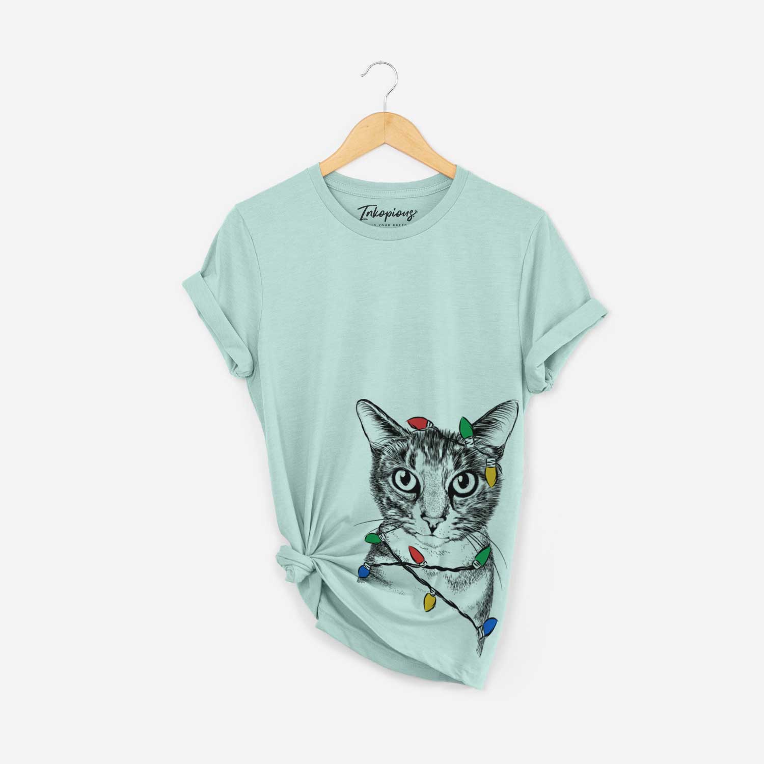 Hand-drawn sketch of Hobbes the Tabby Cat wrapped in Christmas lights on a Heather Sage Unisex crewneck