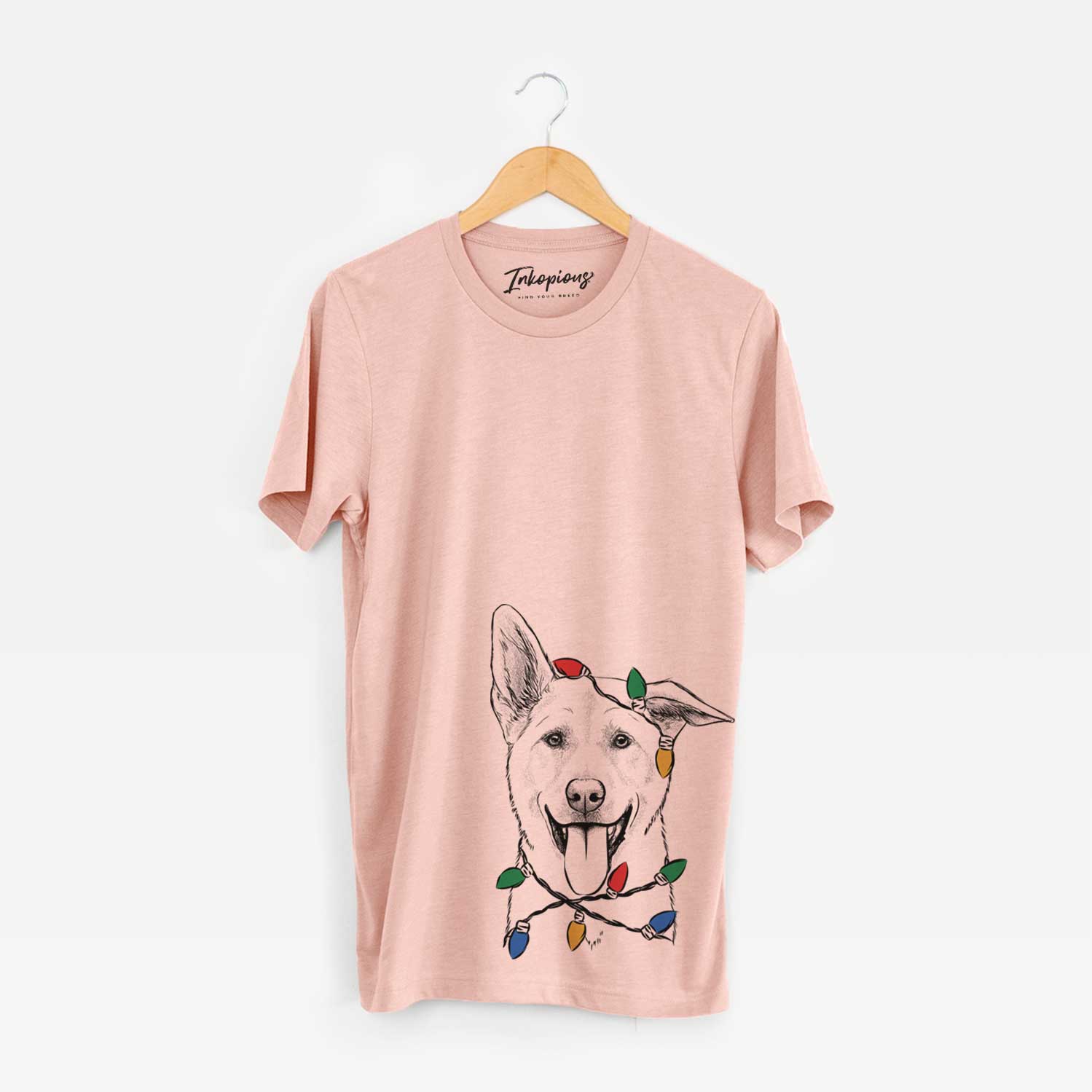 Hand-drawn sketch of Hoya the Korean Jindo wrapped in Christmas lights on a Peach Unisex crewneck
