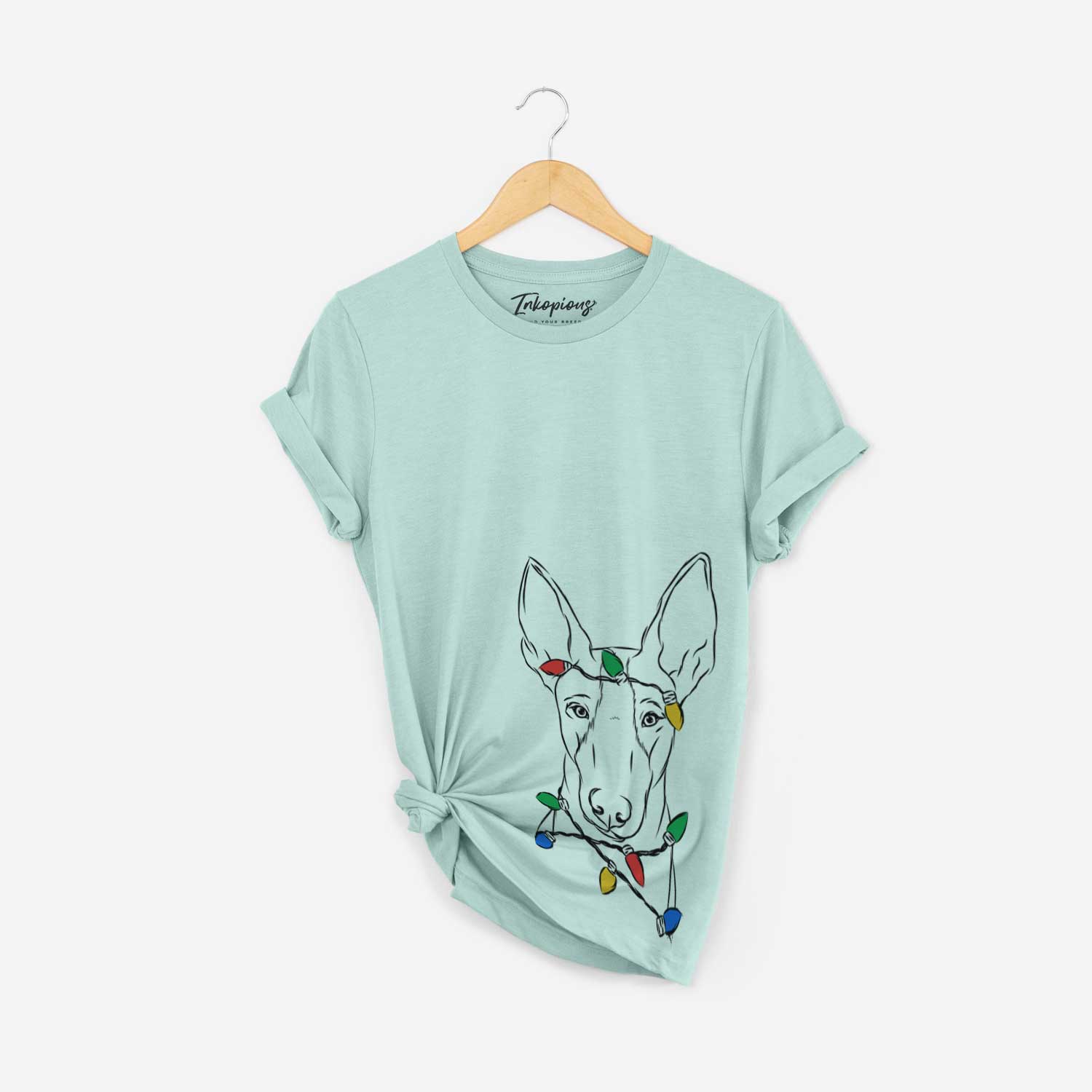 Hand-drawn sketch of Indy the Ibizan Hound wrapped in Christmas lights on a Heather Sage Unisex crewneck