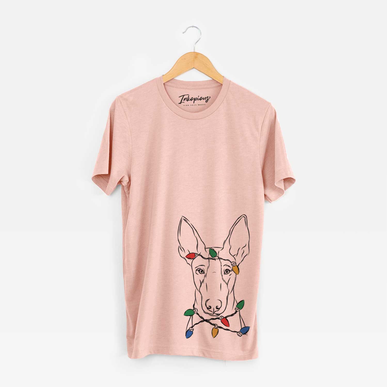 Hand-drawn sketch of Indy the Ibizan Hound wrapped in Christmas lights on a Peach Unisex crewneck