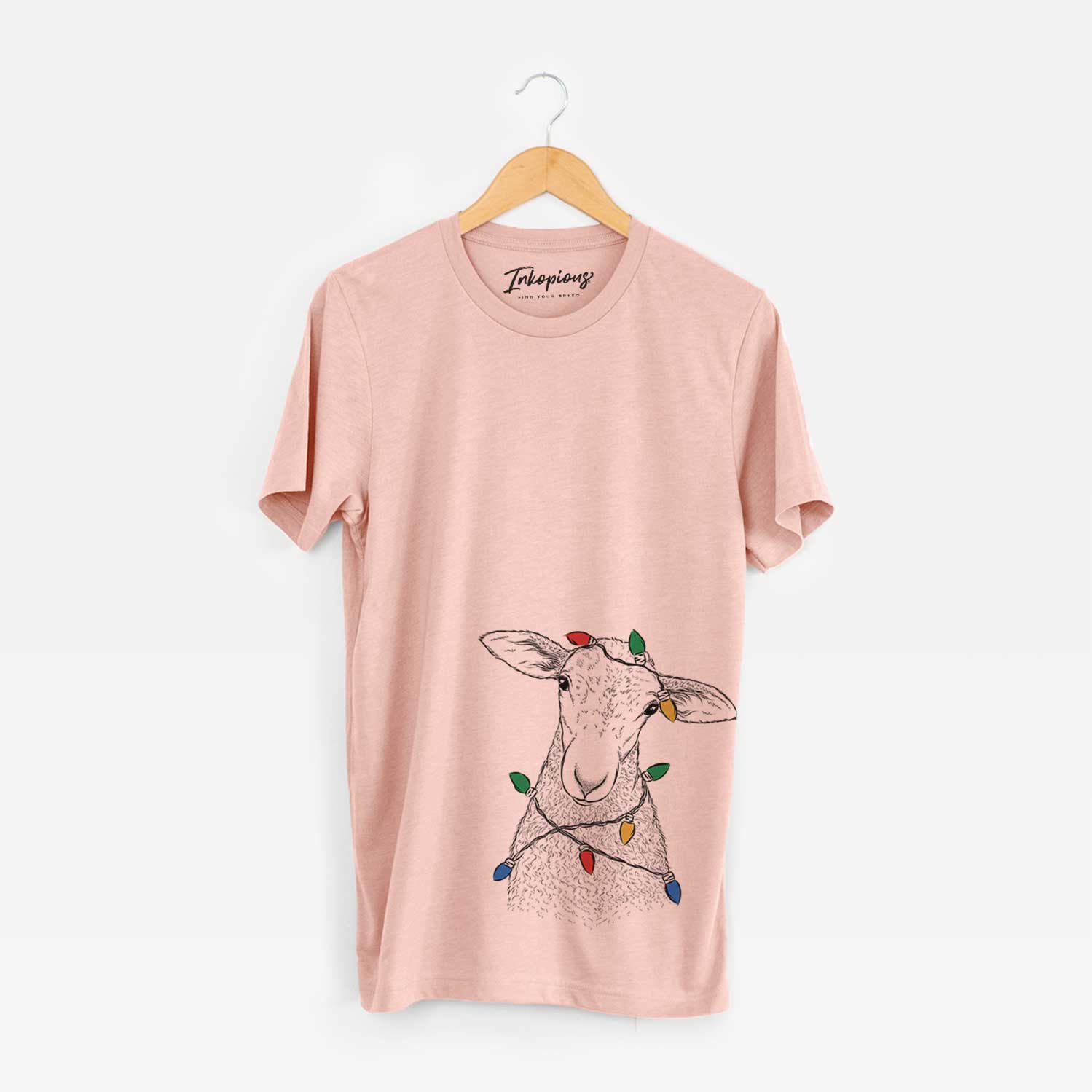 Hand-drawn sketch of Ivy the Lamb wrapped in Christmas lights on a Peach Unisex crewneck