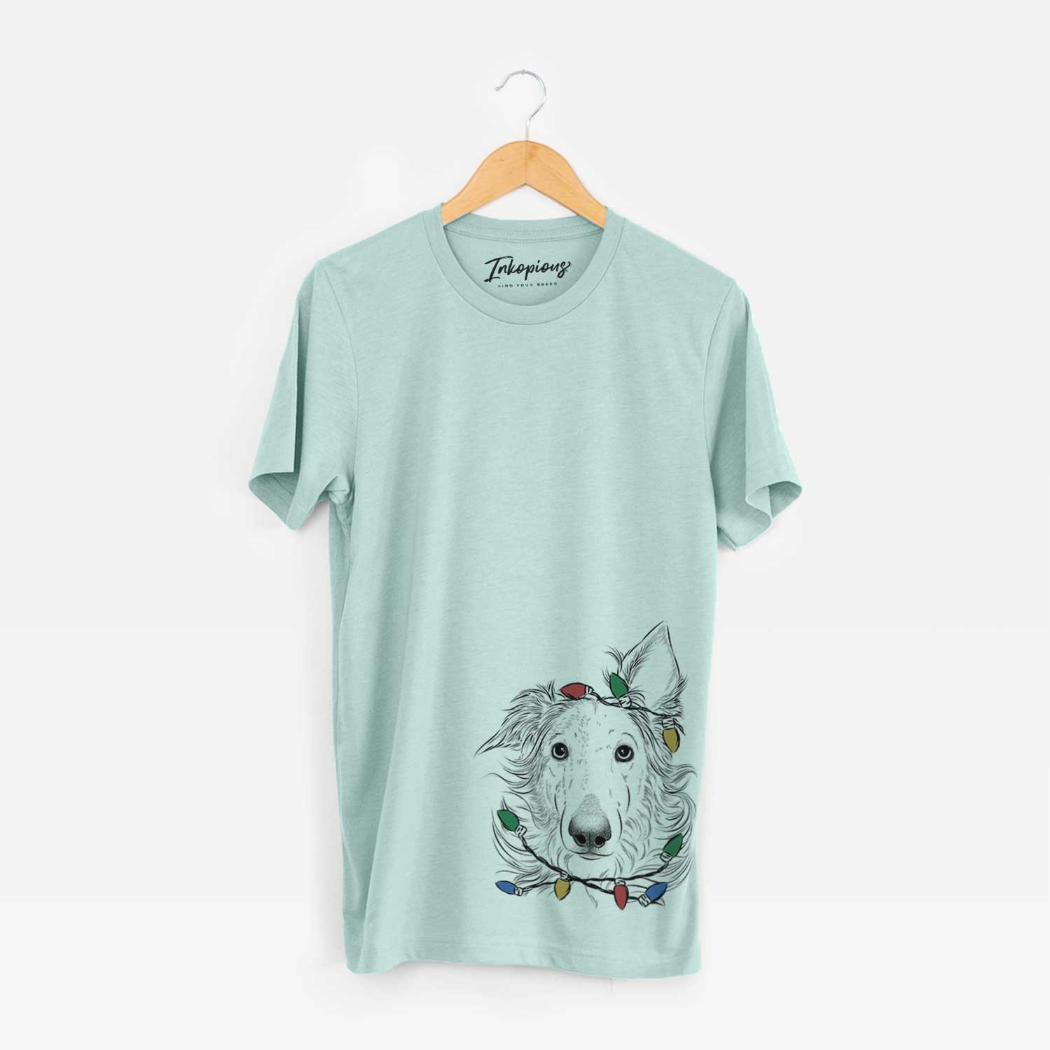 Hand-drawn sketch of Jasha the Borzoi wrapped in Christmas lights on a Heather Sage Unisex crewneck
