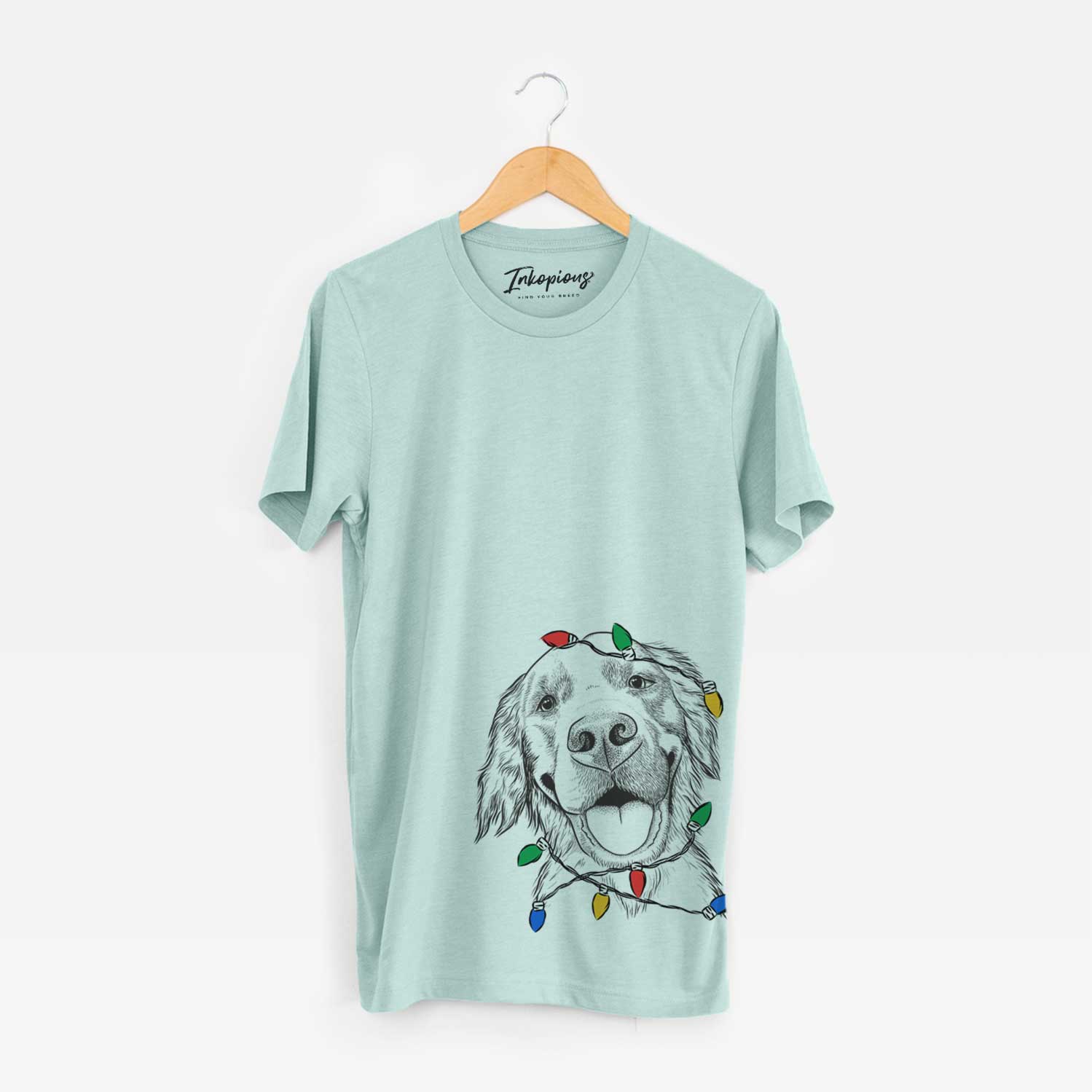 Hand-drawn sketch of Jordy the Golden Retriever wrapped in Christmas lights on a Heather Sage Unisex crewneck