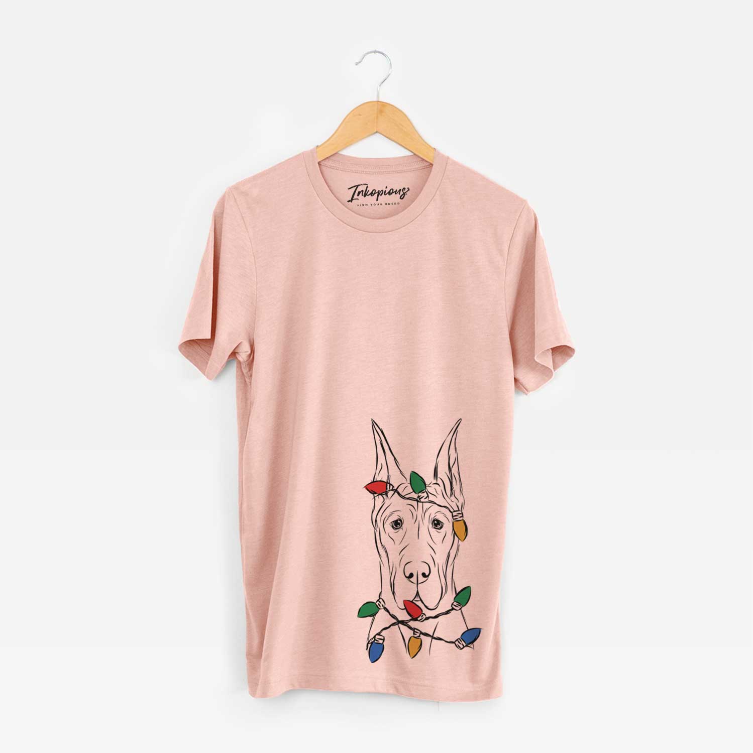 Hand-drawn sketch of Jude the Great Dane wrapped in Christmas lights on a Peach Unisex crewneck
