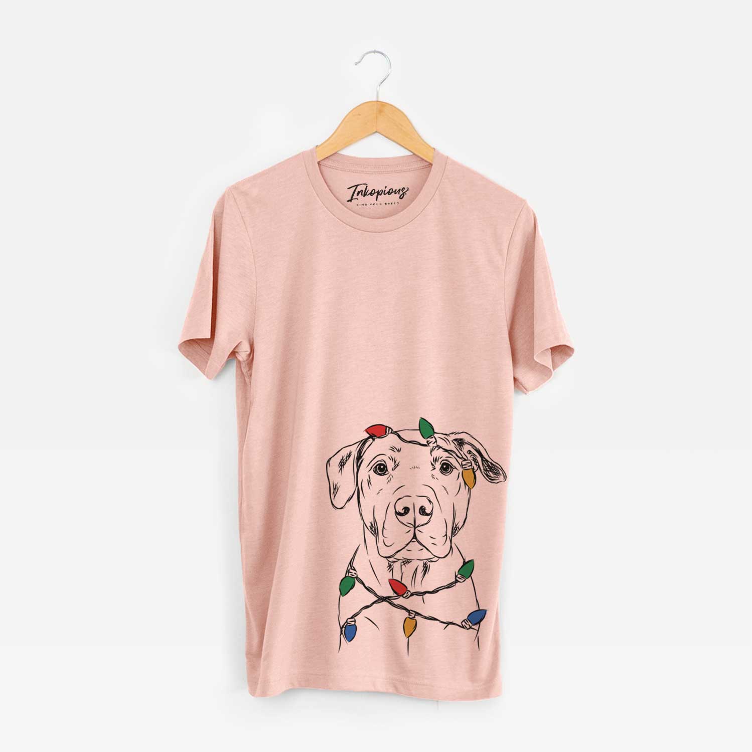Hand-drawn sketch of Kadin the Pitbull wrapped in Christmas lights on a Peach Unisex crewneck