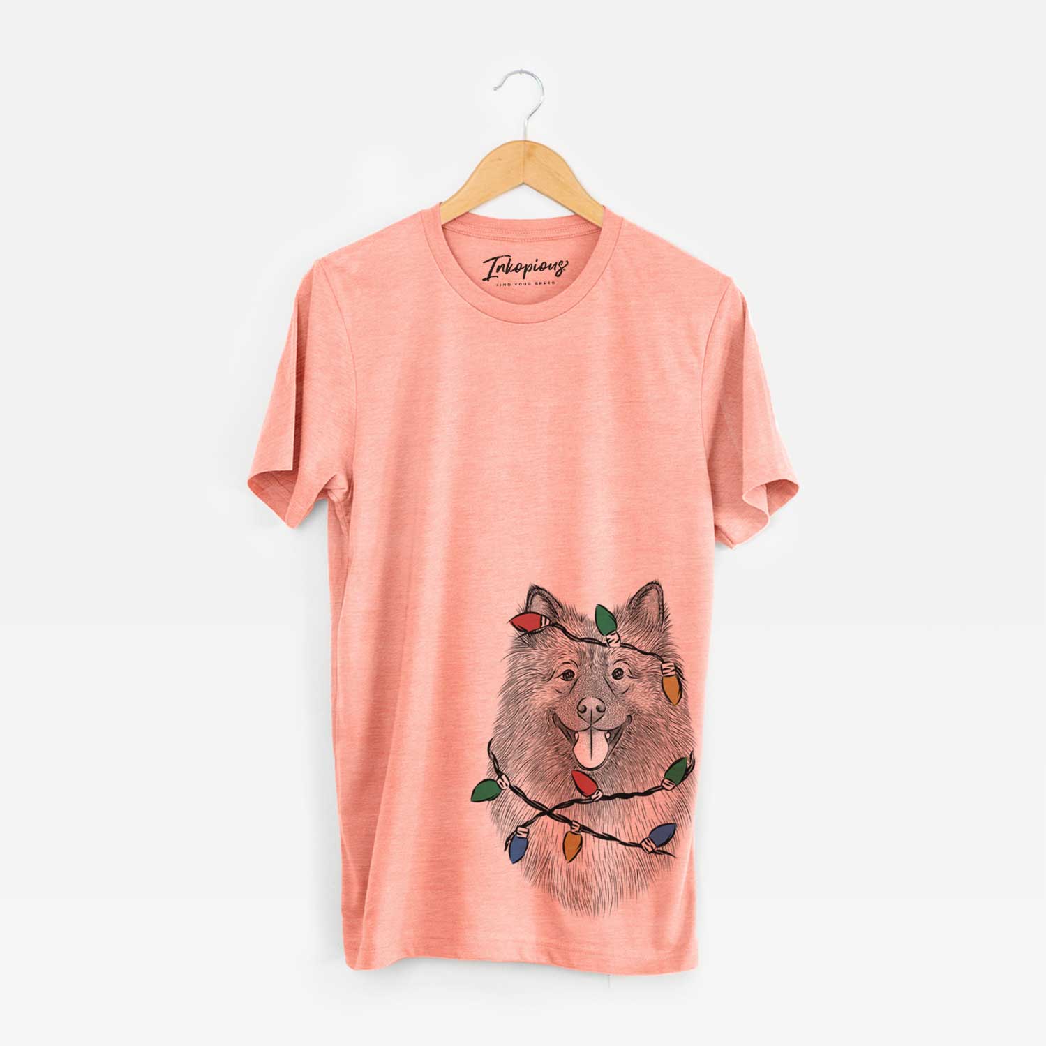 Hand-drawn sketch of Kai the Keeshond wrapped in Christmas lights on a Sunset Unisex crewneck