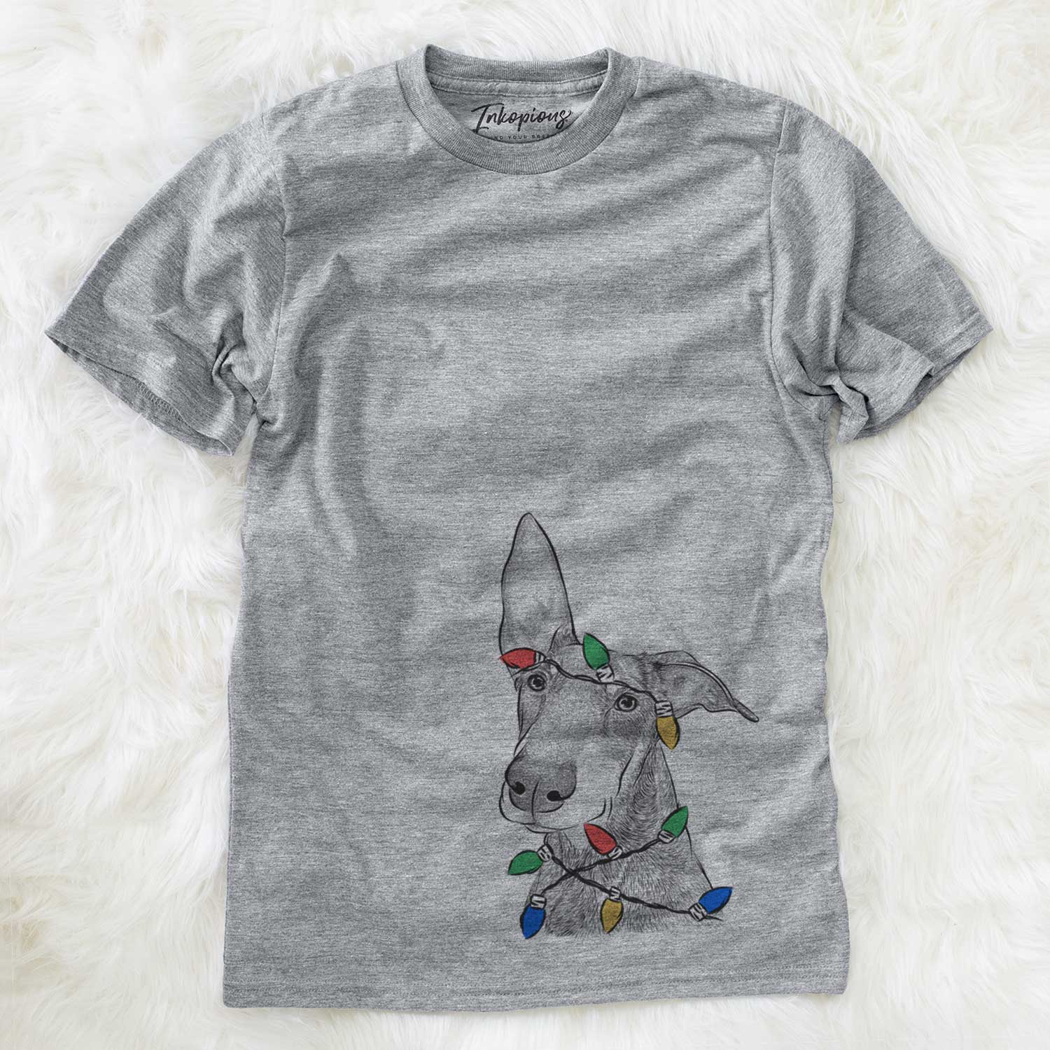 Hand-drawn sketch of Kain the Doberman Pinscher wrapped in Christmas lights on a Grey Unisex crewneck
