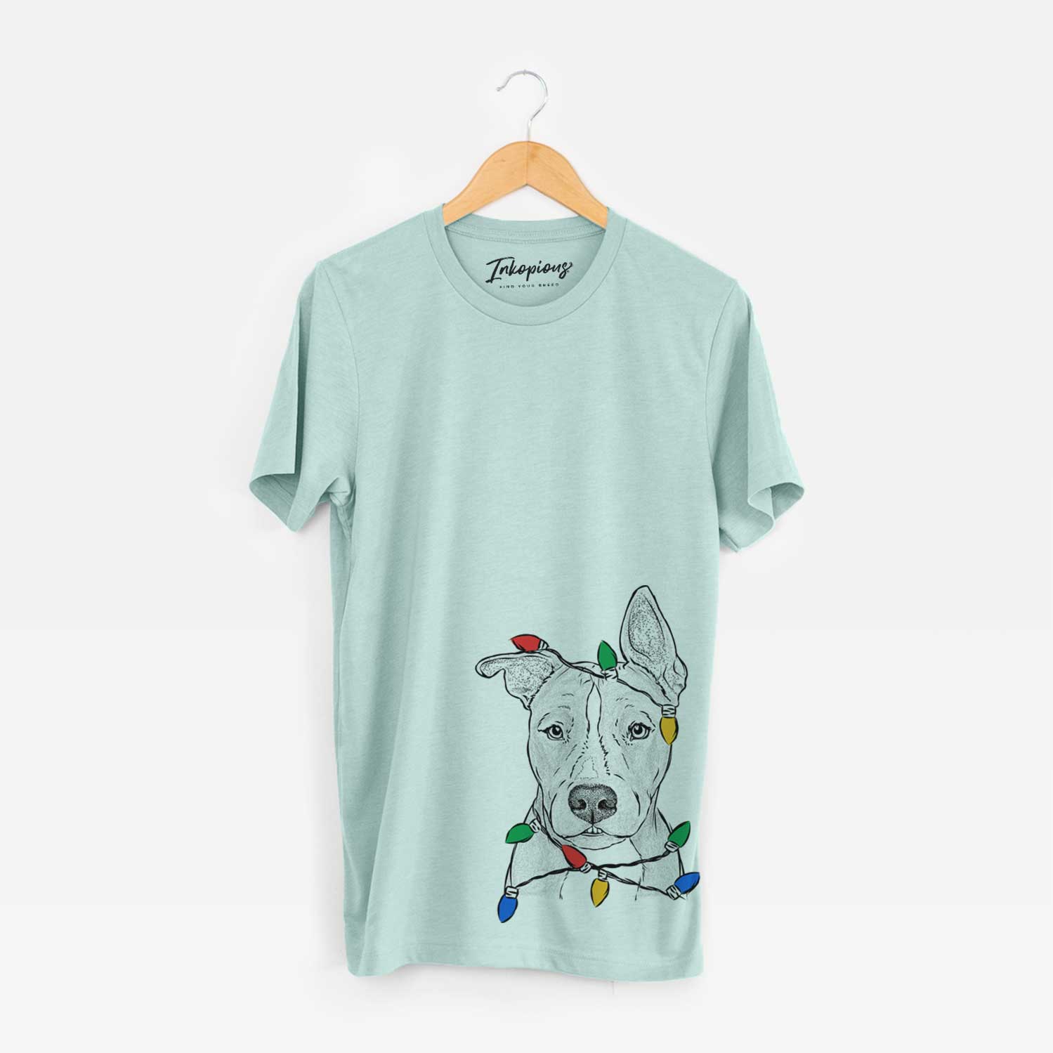 Hand-drawn sketch of Kisses the Pitbull wrapped in Christmas lights on a Heather Sage Unisex crewneck