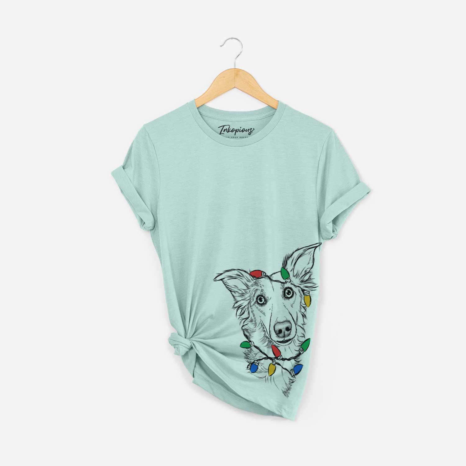 Hand-drawn sketch of Kyu the Windsprite wrapped in Christmas lights on a Heather Sage Unisex crewneck
