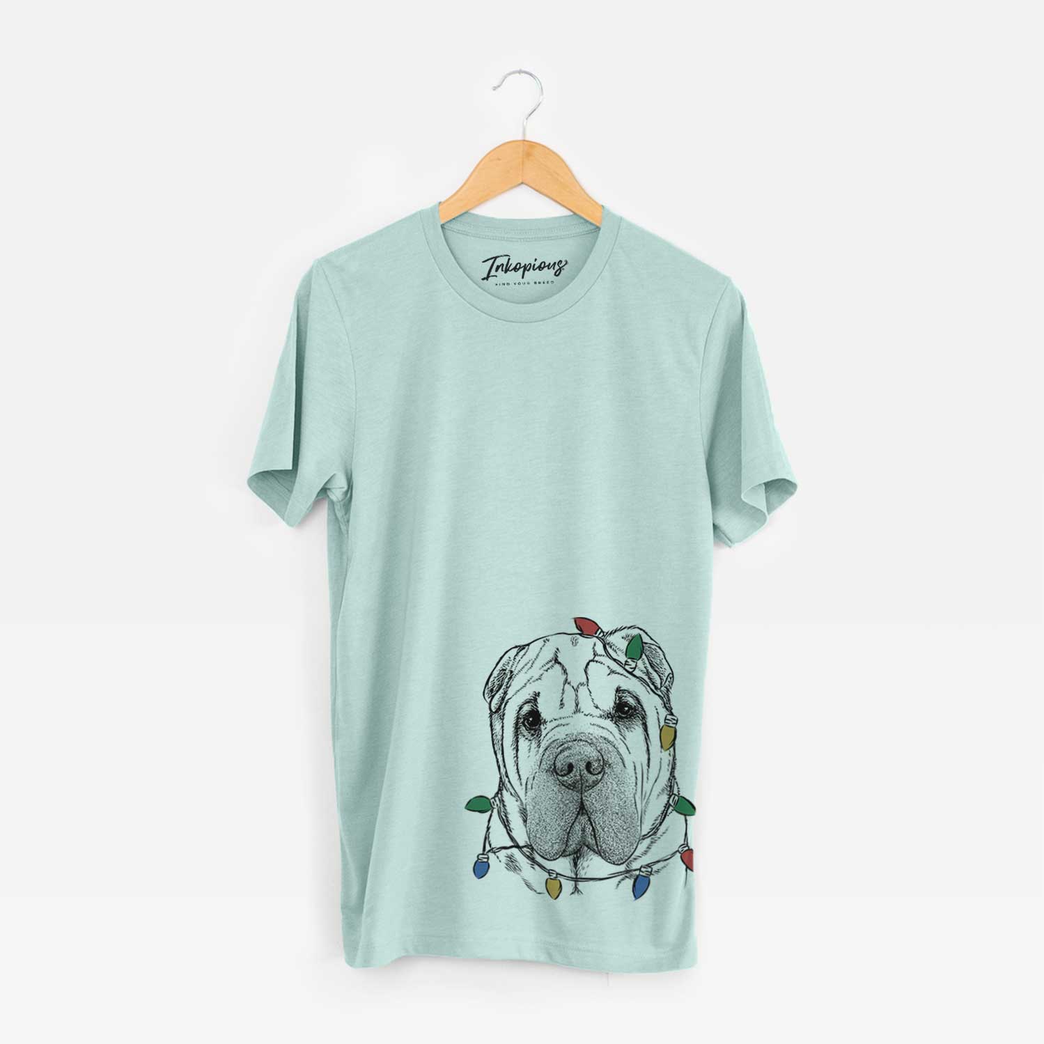 Hand-drawn sketch of Lilly the Shar Pei wrapped in Christmas lights on a Heather Sage Unisex crewneck