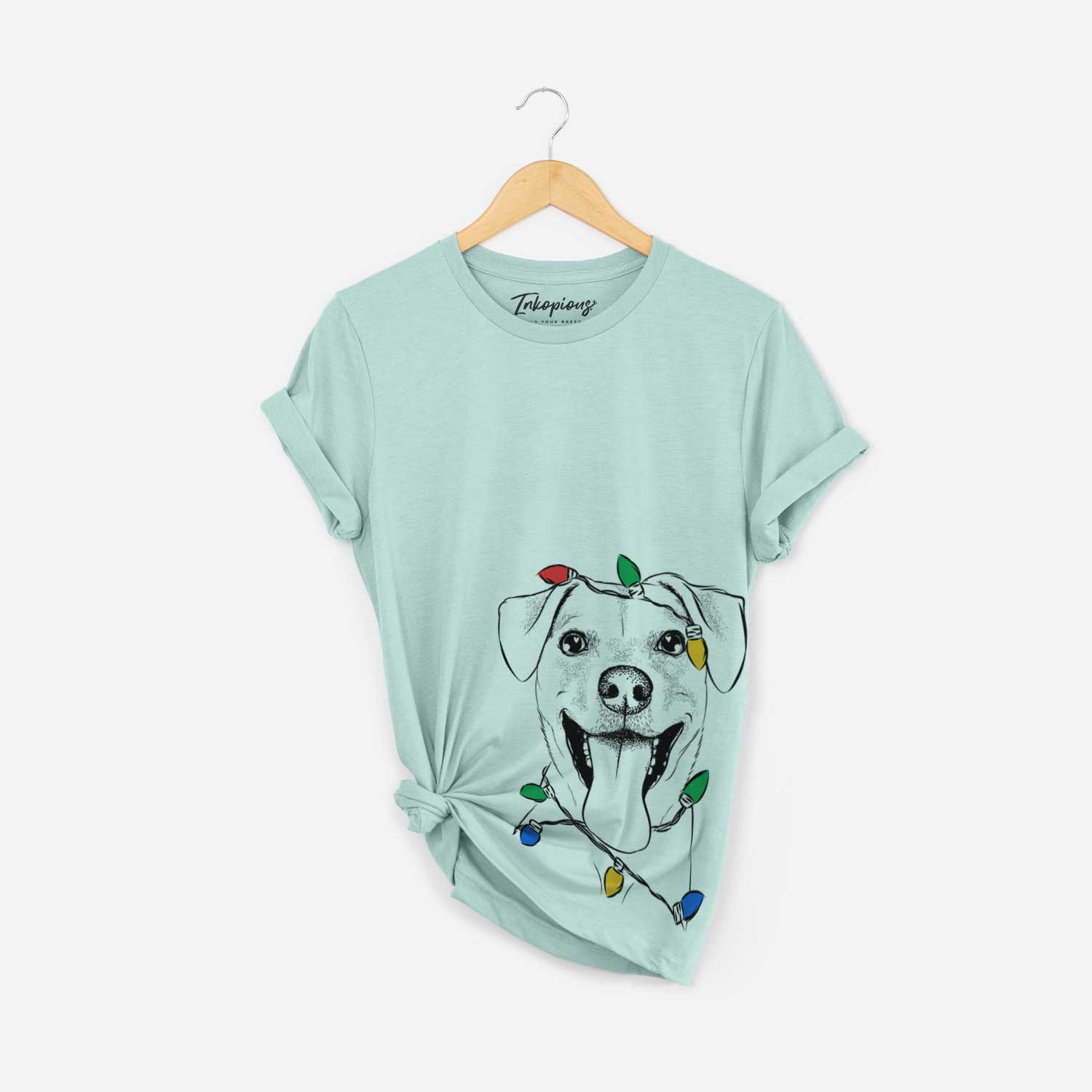 Hand-drawn sketch of Lily Estelle the Mixed Breed wrapped in Christmas lights on a Heather Sage Unisex crewneck