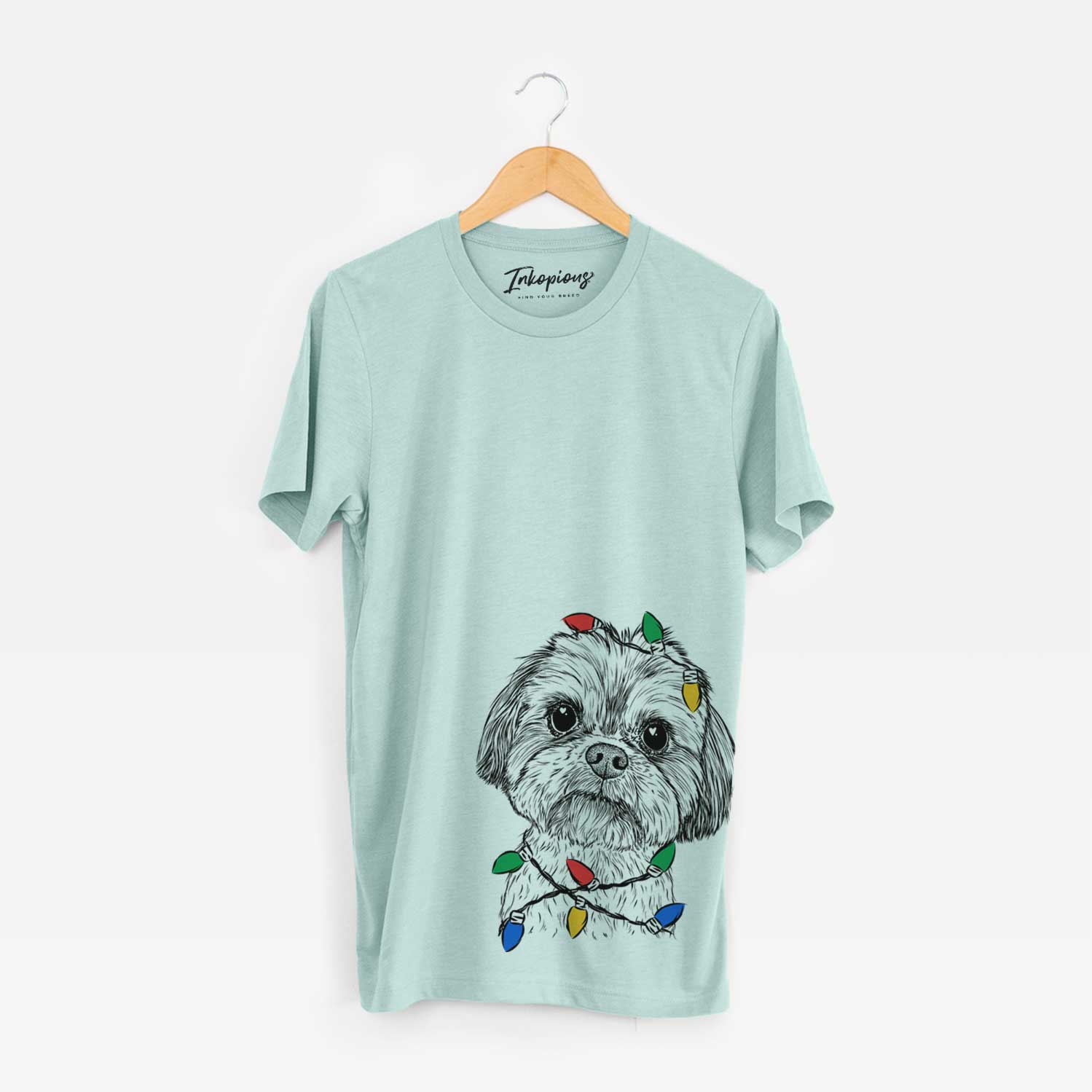 Hand-drawn sketch of Lucy the Shorkie wrapped in Christmas lights on a Heather Sage Unisex crewneck