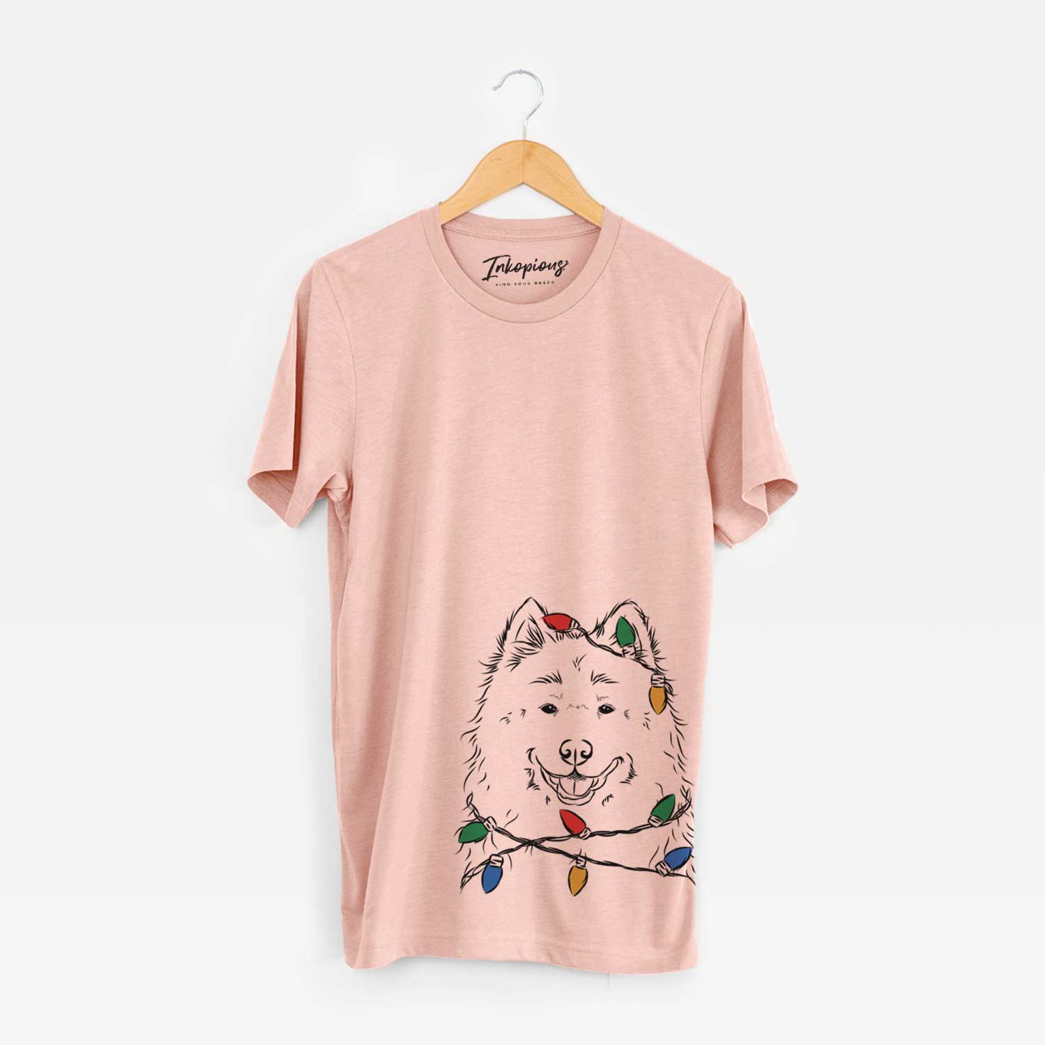 Hand-drawn sketch of Luka the Samoyed wrapped in Christmas lights on a Peach Unisex crewneck