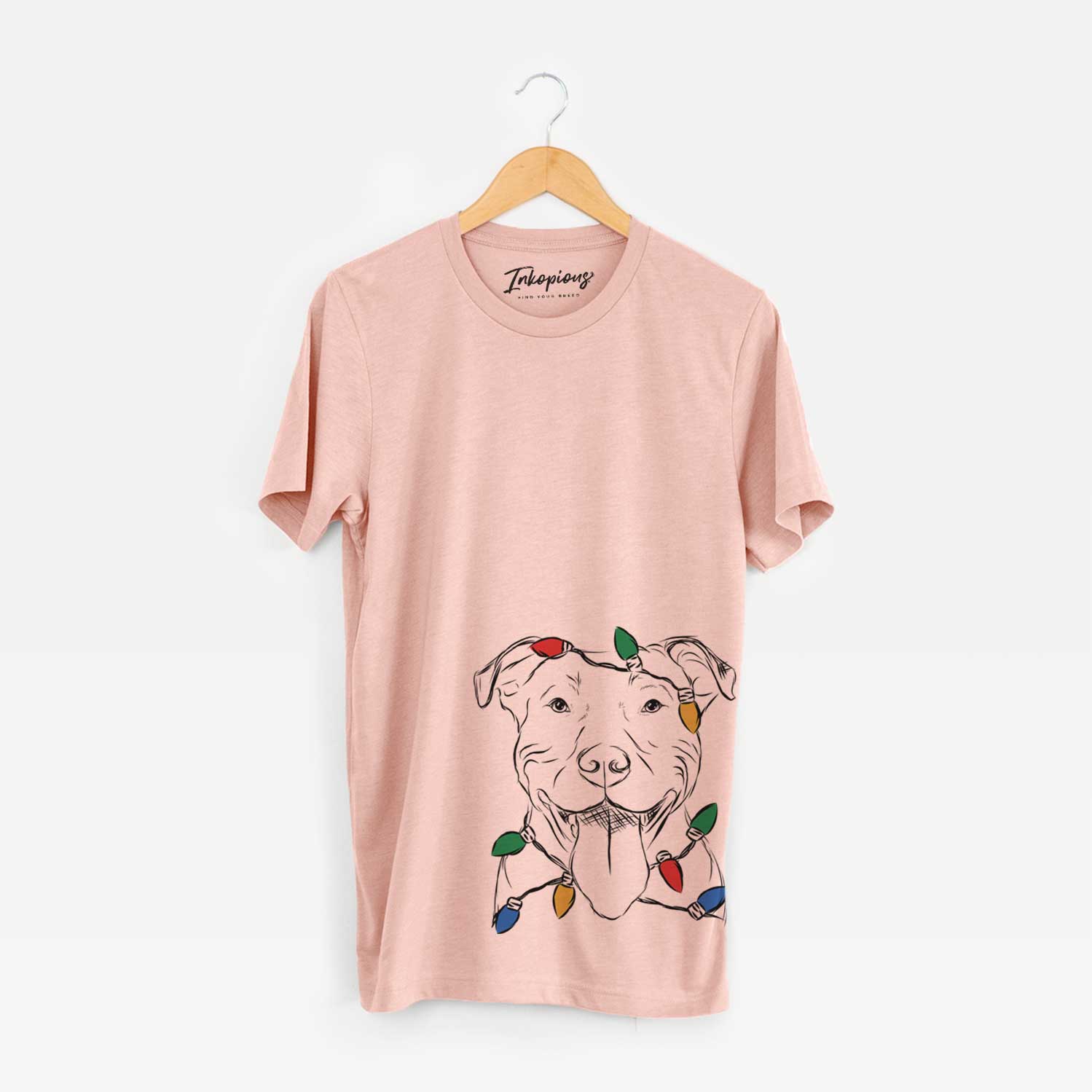 Hand-drawn sketch of Major the Pitbull wrapped in Christmas lights on a Peach Unisex crewneck