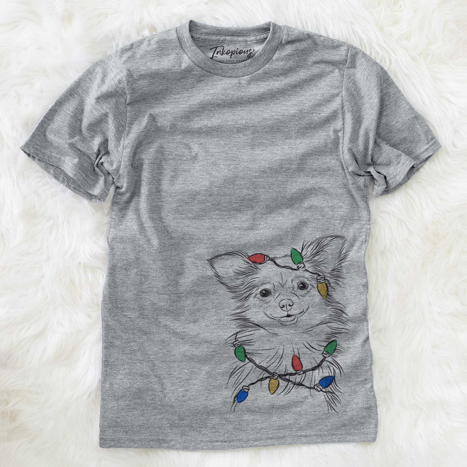 Hand-drawn sketch of Marzi the Long Haired Chihuahua wrapped in Christmas lights on a Grey Unisex crewneck