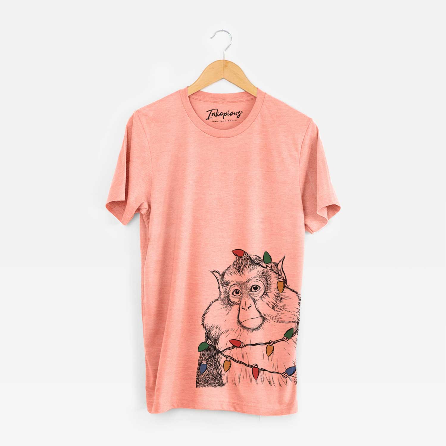 Hand-drawn sketch of Matata the Mona Monkey wrapped in Christmas lights on a Sunset Unisex crewneck