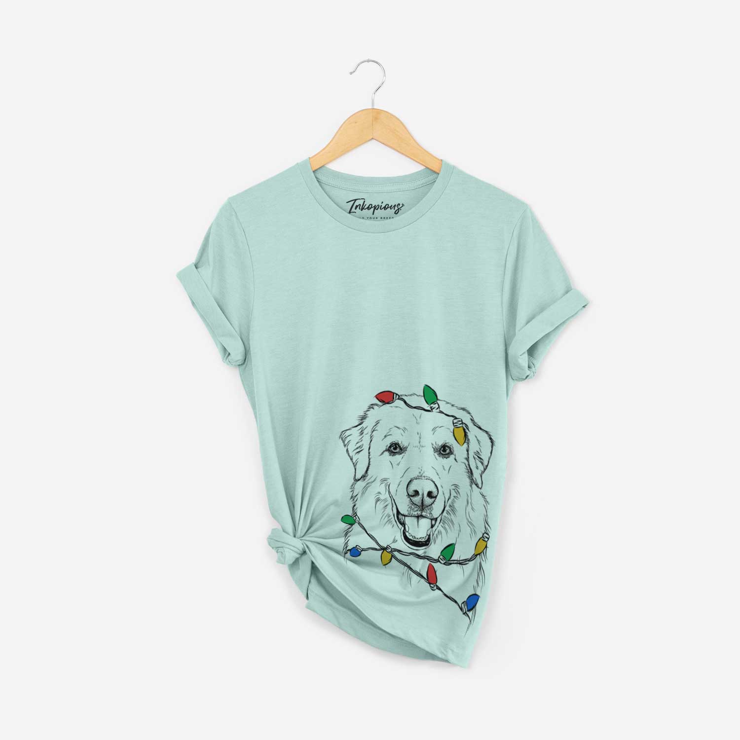 Hand-drawn sketch of Meg the Great Pyrenees wrapped in Christmas lights on a Heather Sage Unisex crewneck