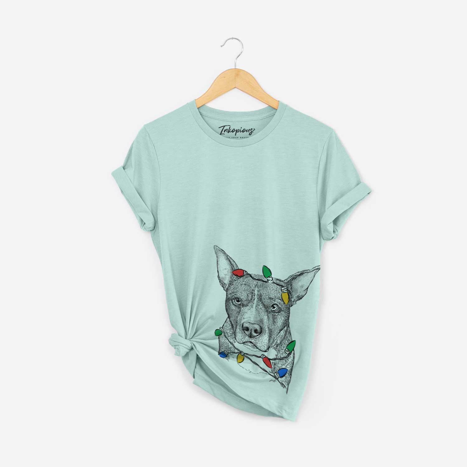 Hand-drawn sketch of Mercy the Pitbull wrapped in Christmas lights on a Heather Sage Unisex crewneck