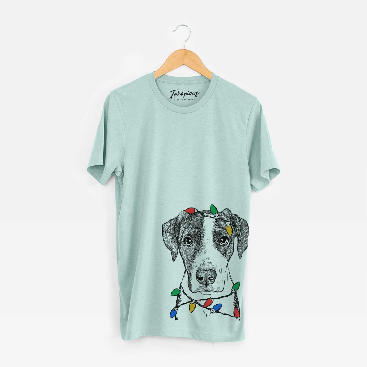 Hand-drawn sketch of Milo the Mixed Breed wrapped in Christmas lights on a Heather Sage Unisex crewneck
