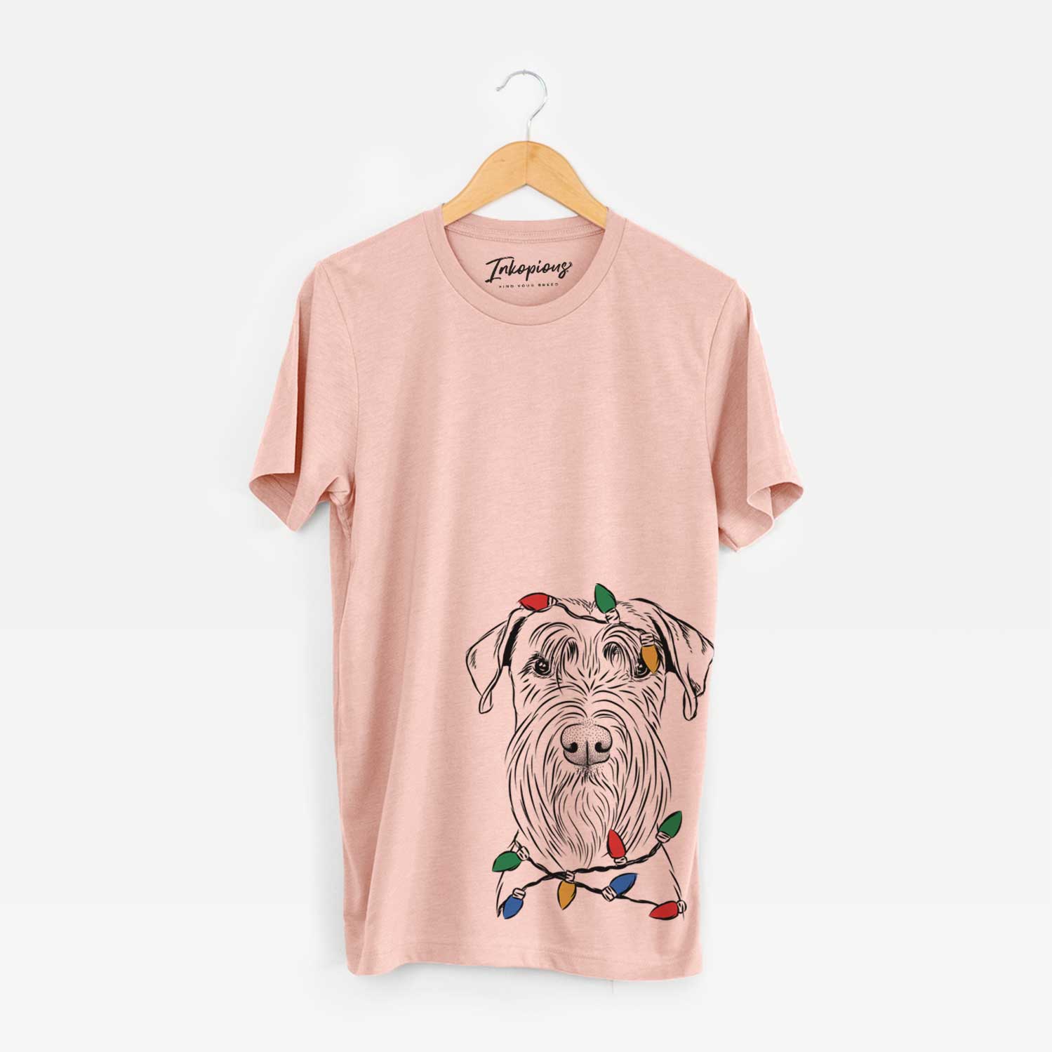 Hand-drawn sketch of Milton the Schnauzer wrapped in Christmas lights on a Peach Unisex crewneck
