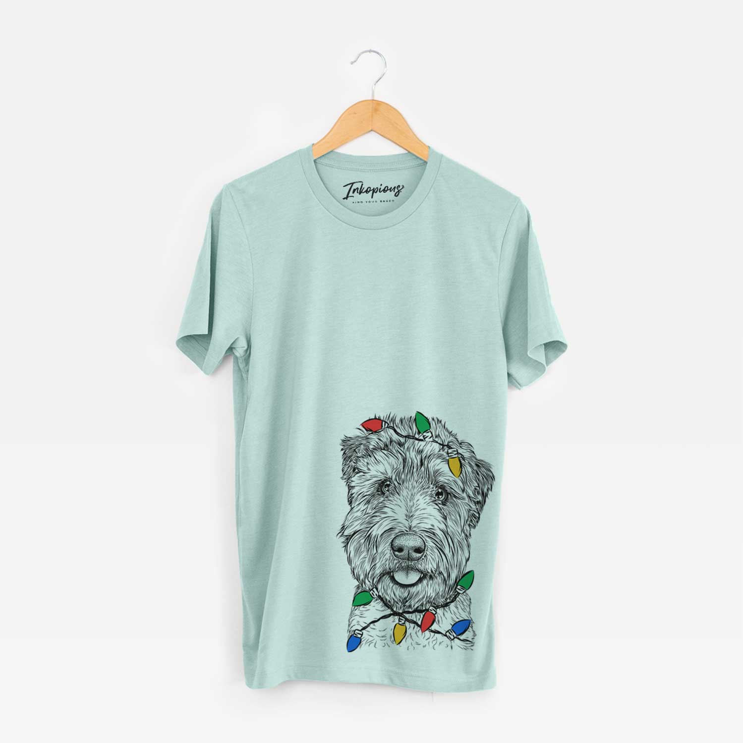 Hand-drawn sketch of Milton the Soft Coated Wheaten Terrier wrapped in Christmas lights on a Heather Sage Unisex crewneck