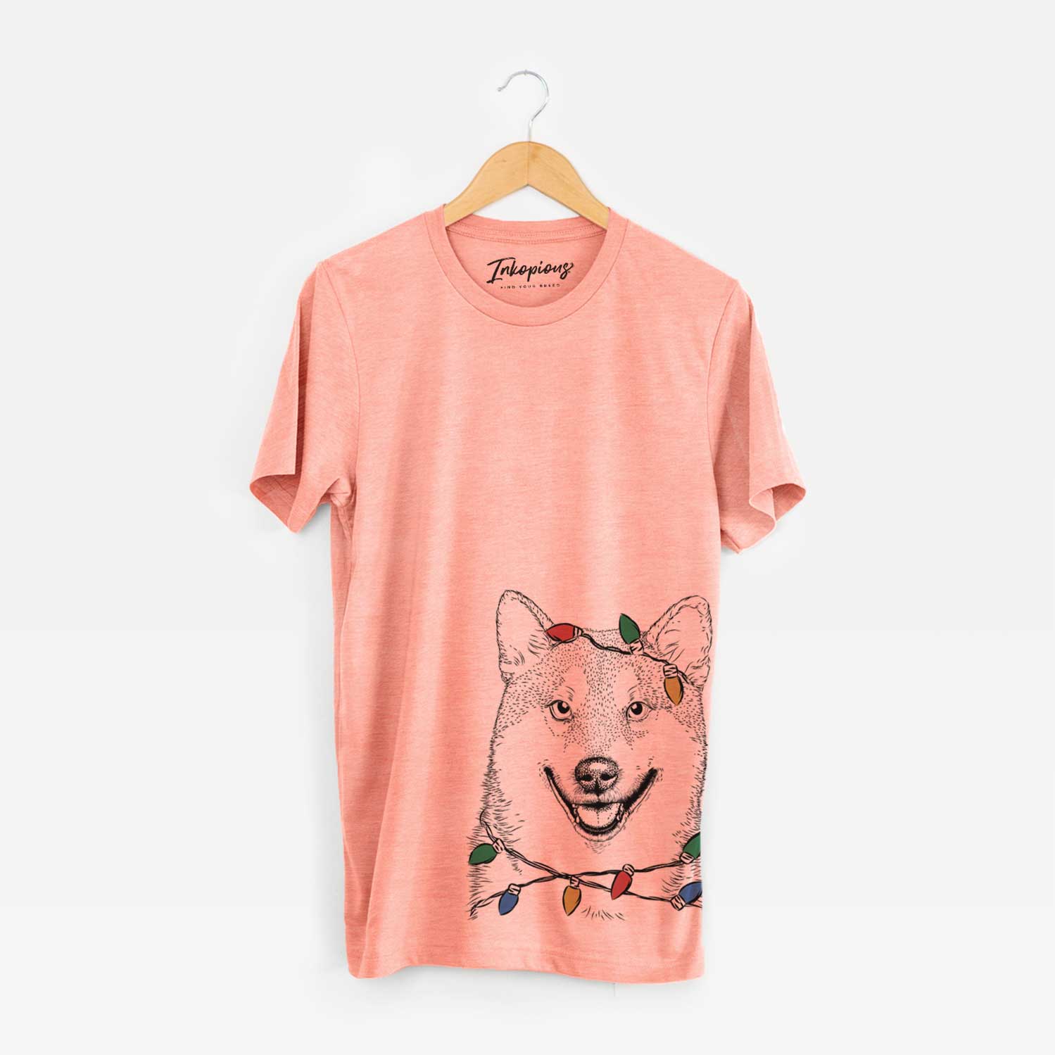Hand-drawn sketch of Mitsu the Shiba Inu wrapped in Christmas lights on a Sunset Unisex crewneck