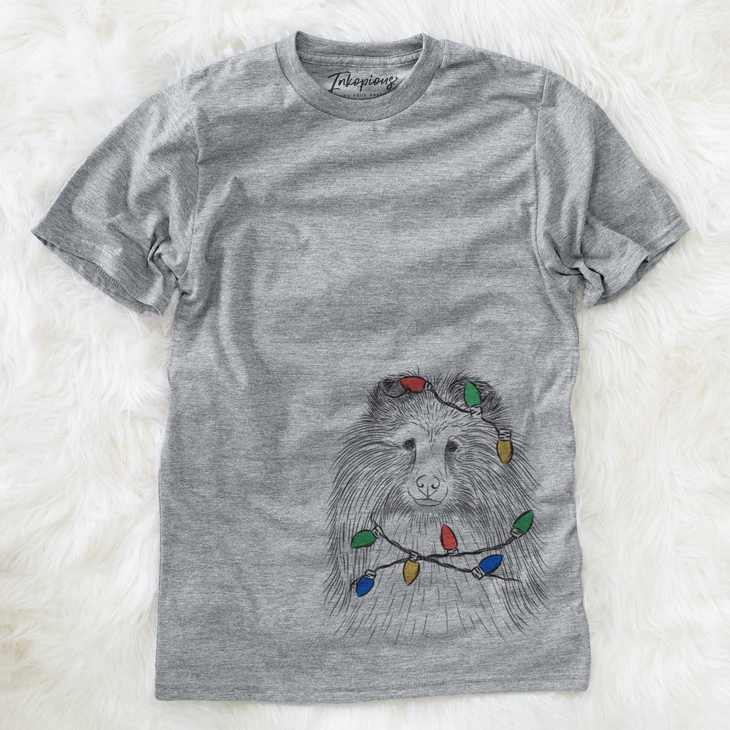 Hand-drawn sketch of Moxie the Shetland Sheepdog wrapped in Christmas lights on a Grey Unisex crewneck