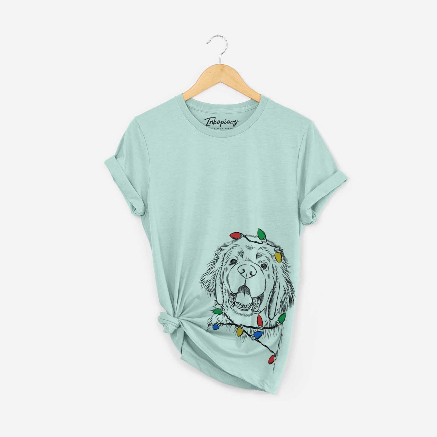 Hand-drawn sketch of Mozart the Newfoundland wrapped in Christmas lights on a Heather Sage Unisex crewneck