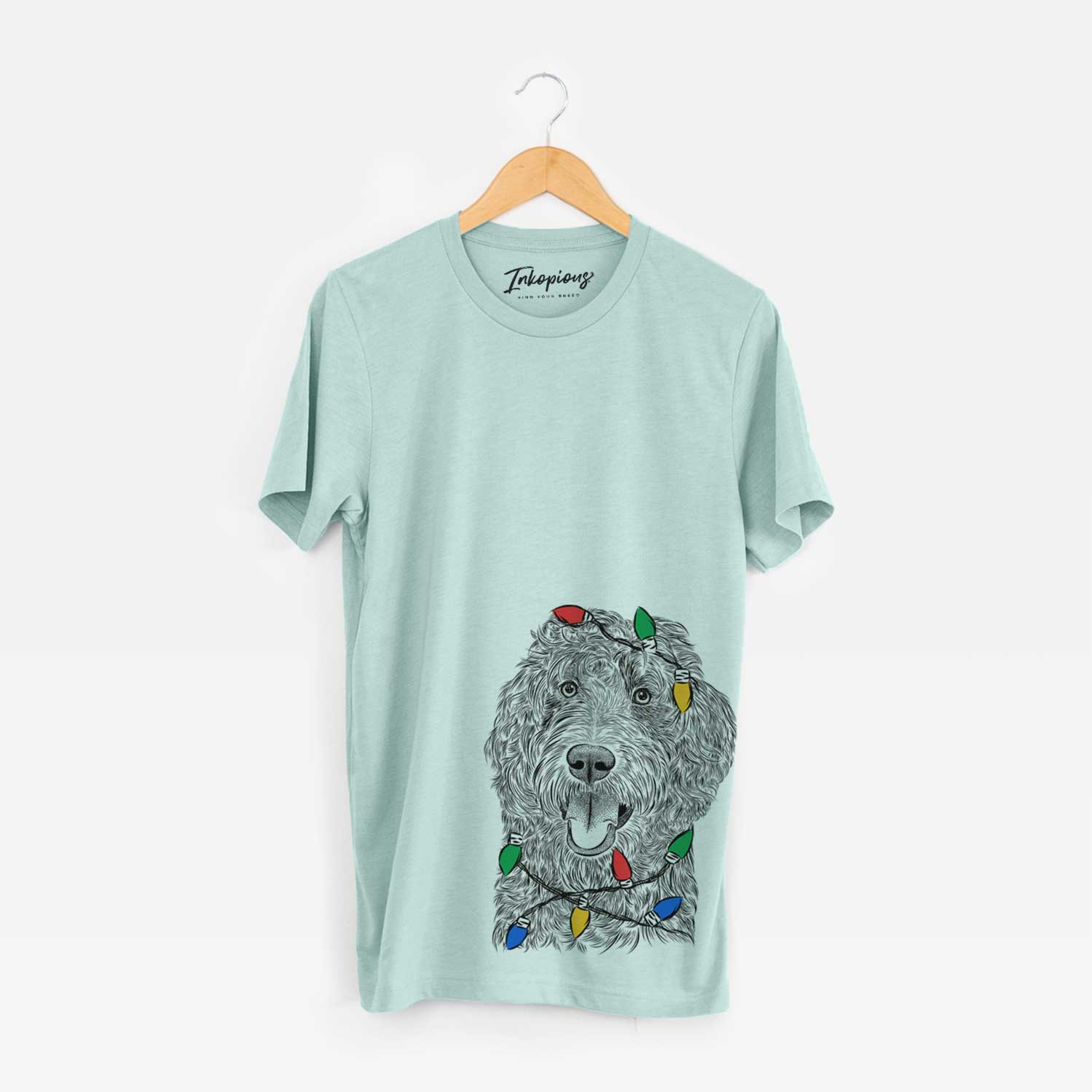 Hand-drawn sketch of Murr Dog the Labradoodle wrapped in Christmas lights on a Heather Sage Unisex crewneck