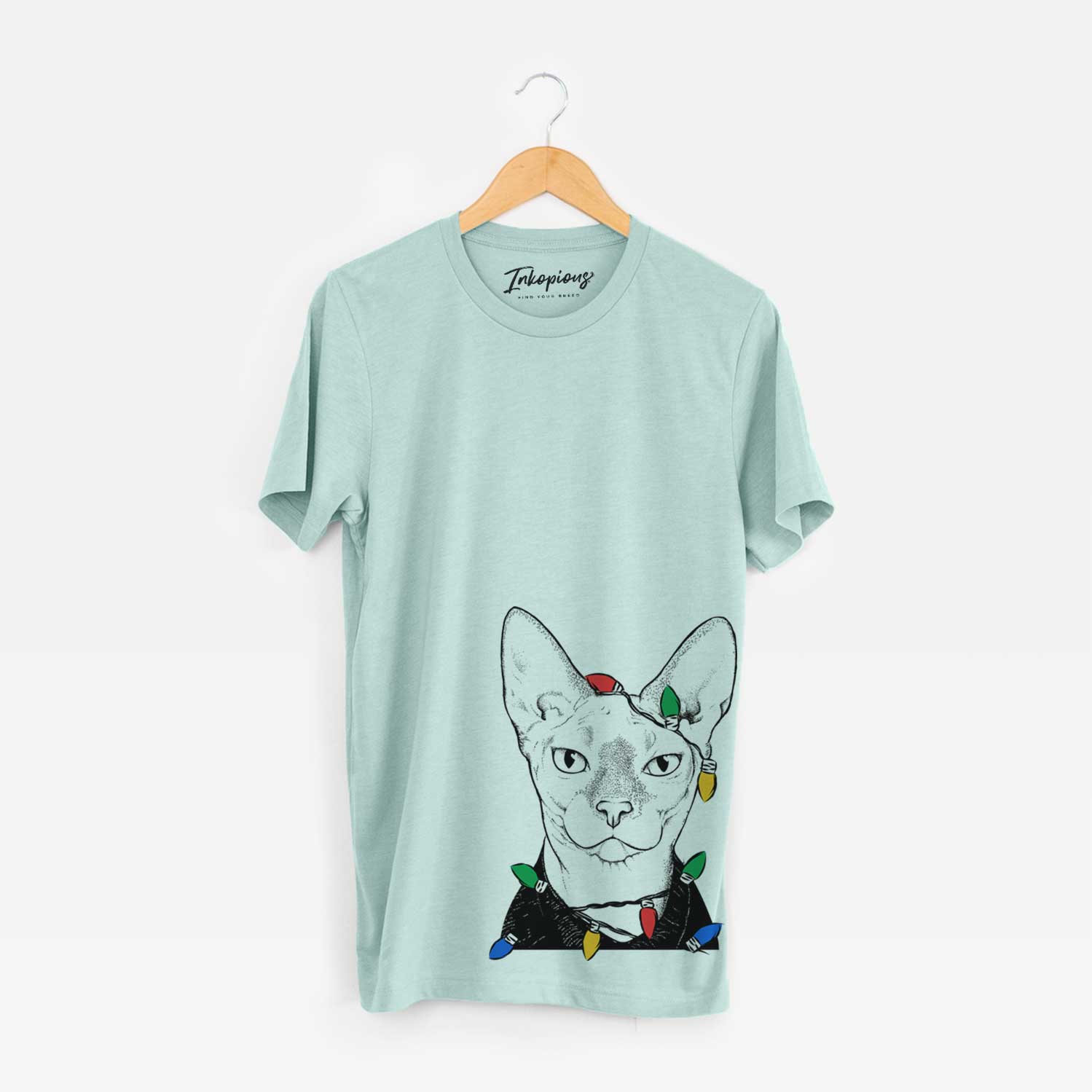 Hand-drawn sketch of Oliver Watson the Sphynx Cat wrapped in Christmas lights on a Heather Sage Unisex crewneck