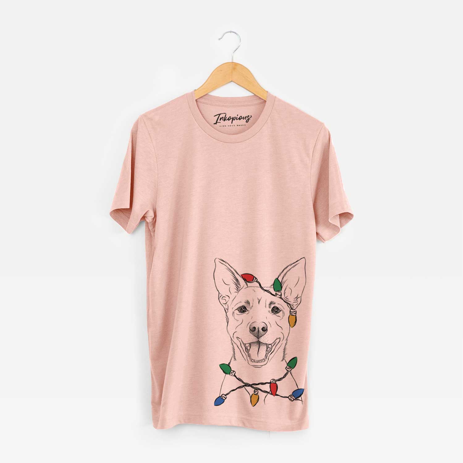 Hand-drawn sketch of Orange the Carolina Dog wrapped in Christmas lights on a Peach Unisex crewneck