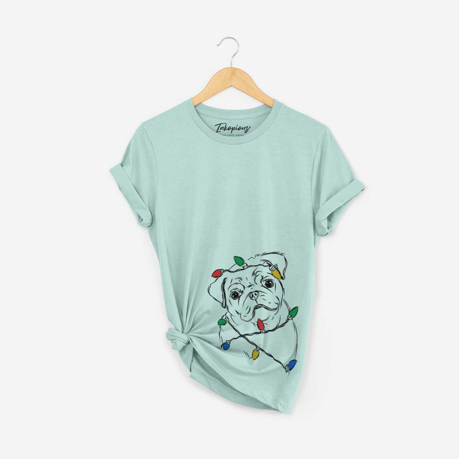 Hand-drawn sketch of Otis the Pug wrapped in Christmas lights on a Heather Sage Unisex crewneck