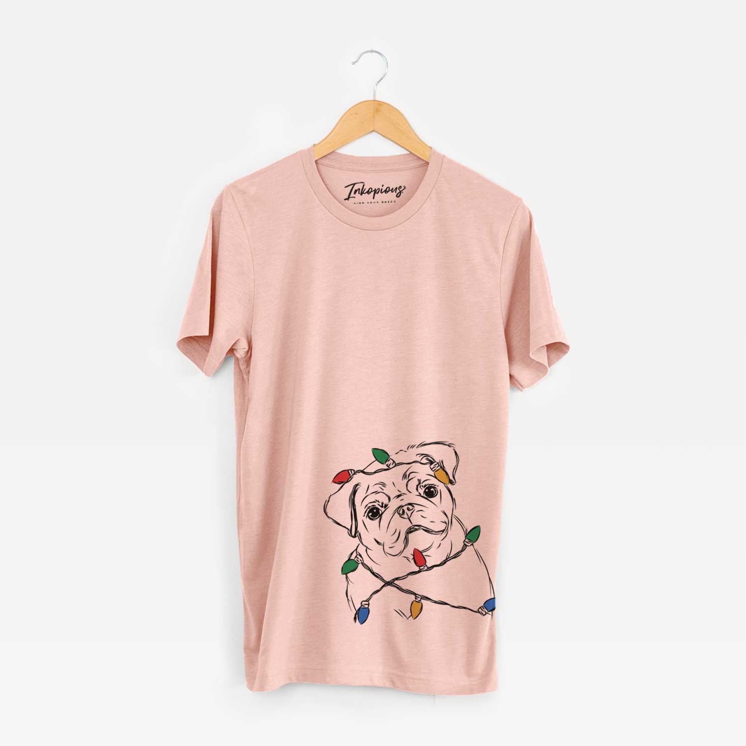 Hand-drawn sketch of Otis the Pug wrapped in Christmas lights on a Peach Unisex crewneck