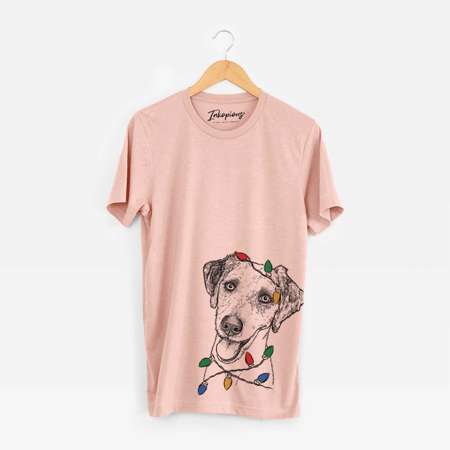 Hand-drawn sketch of Palm Palm the Aussiedoodle wrapped in Christmas lights on a Peach Unisex crewneck
