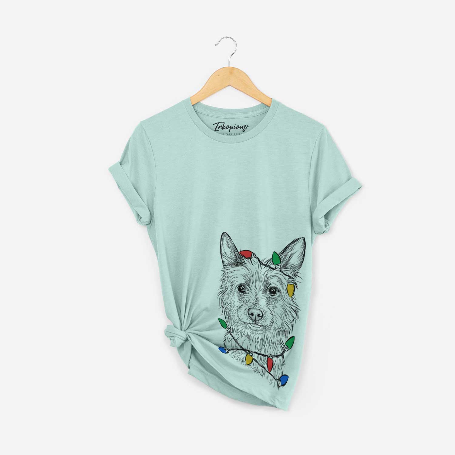 Hand-drawn sketch of Paulo the Portuguese Podengo wrapped in Christmas lights on a Heather Sage Unisex crewneck