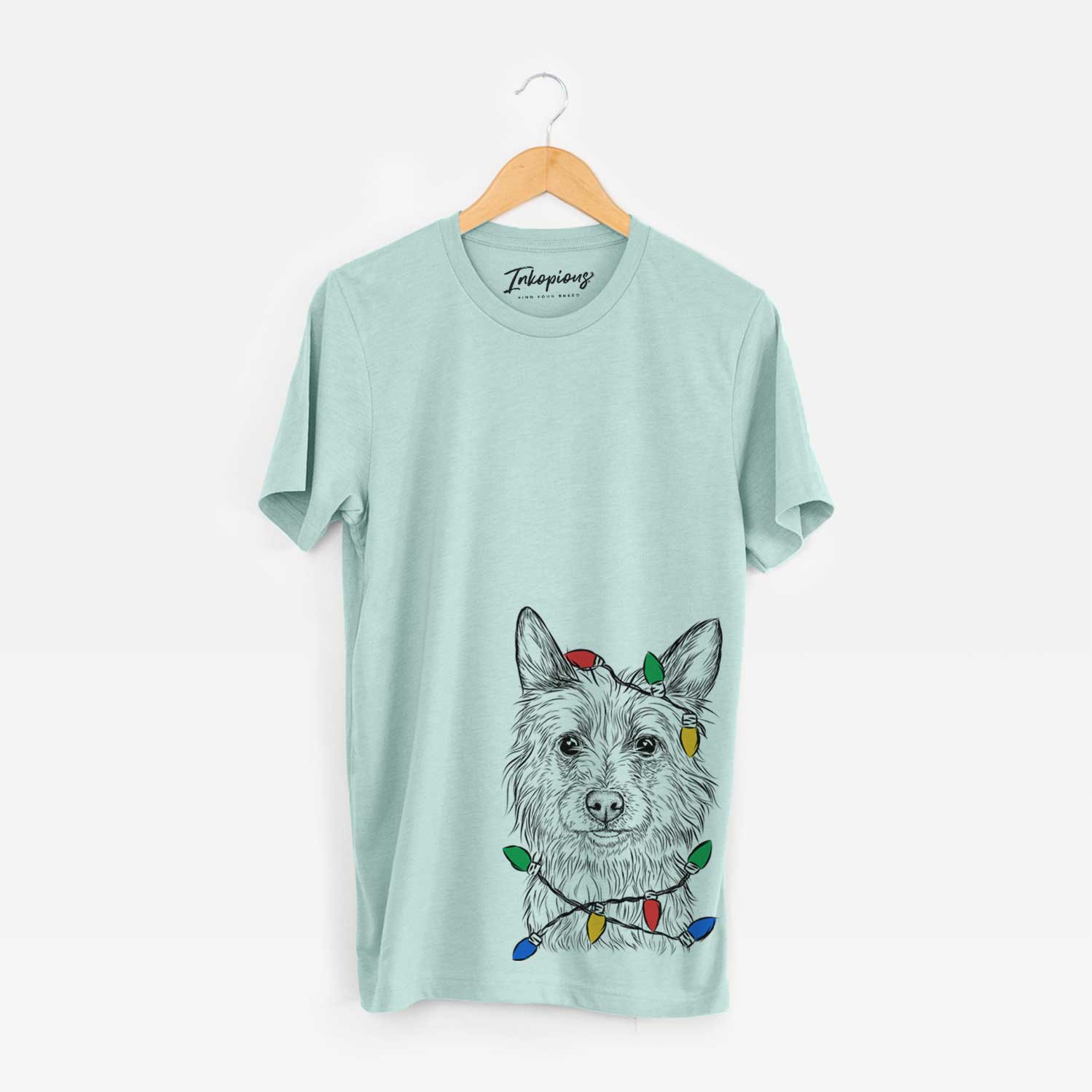Hand-drawn sketch of Paulo the Portuguese Podengo wrapped in Christmas lights on a Heather Sage Unisex crewneck