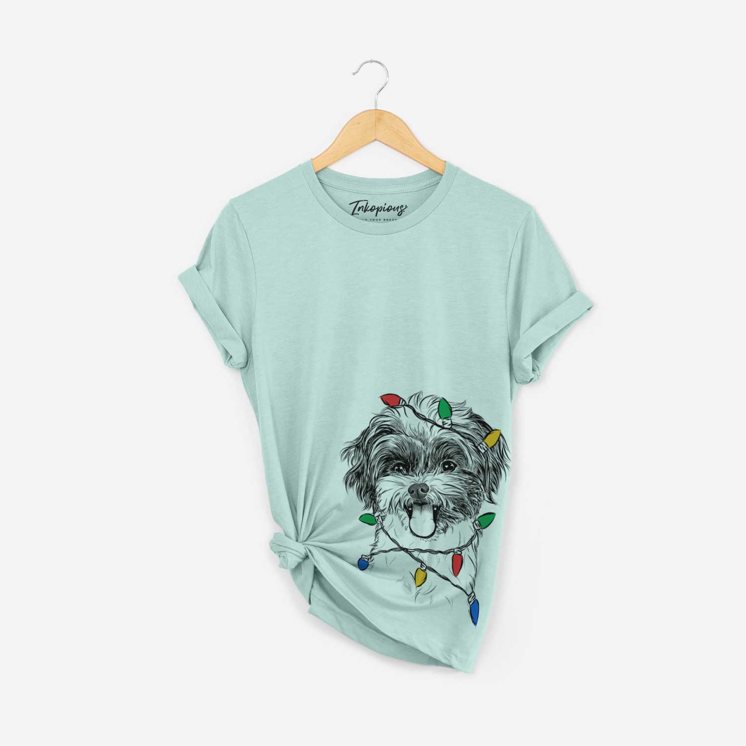 Hand-drawn sketch of Pepper the Shihpoo wrapped in Christmas lights on a Heather Sage Unisex crewneck