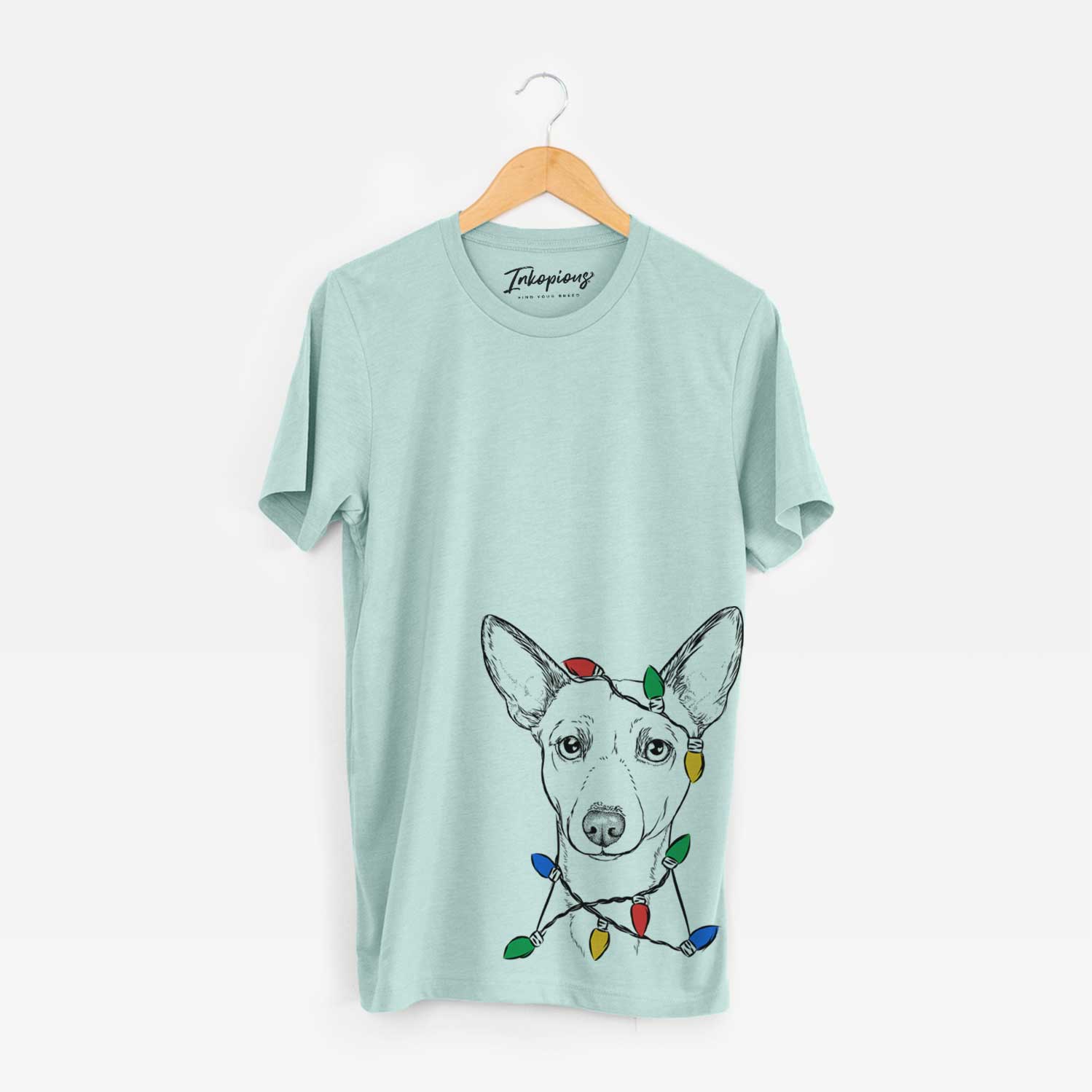 Hand-drawn sketch of Perry the Portuguese Podengo wrapped in Christmas lights on a Heather Sage Unisex crewneck