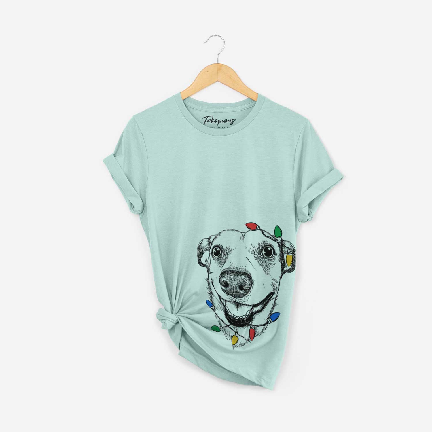 Hand-drawn sketch of Petrah the Staffy Mix wrapped in Christmas lights on a Heather Sage Unisex crewneck
