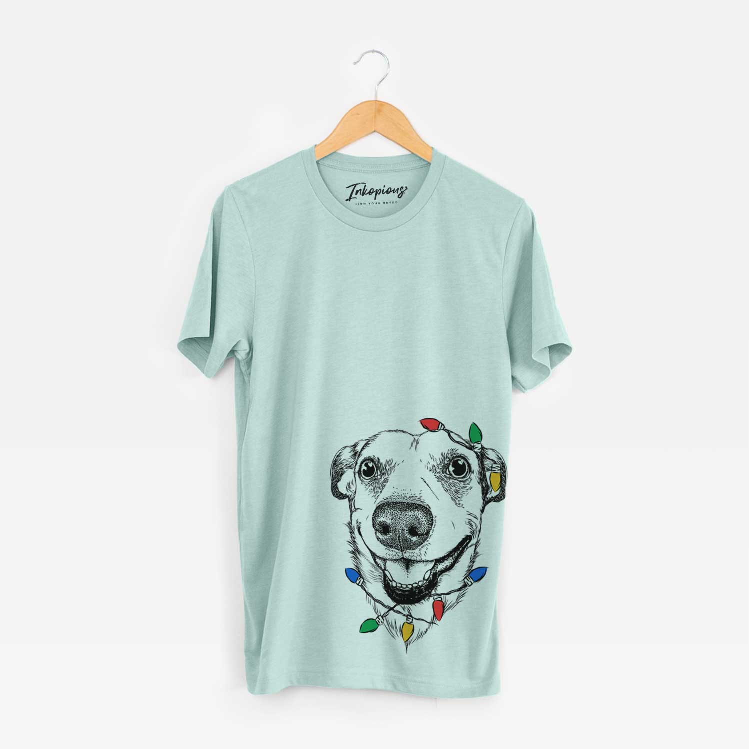 Hand-drawn sketch of Petrah the Staffy Mix wrapped in Christmas lights on a Heather Sage Unisex crewneck