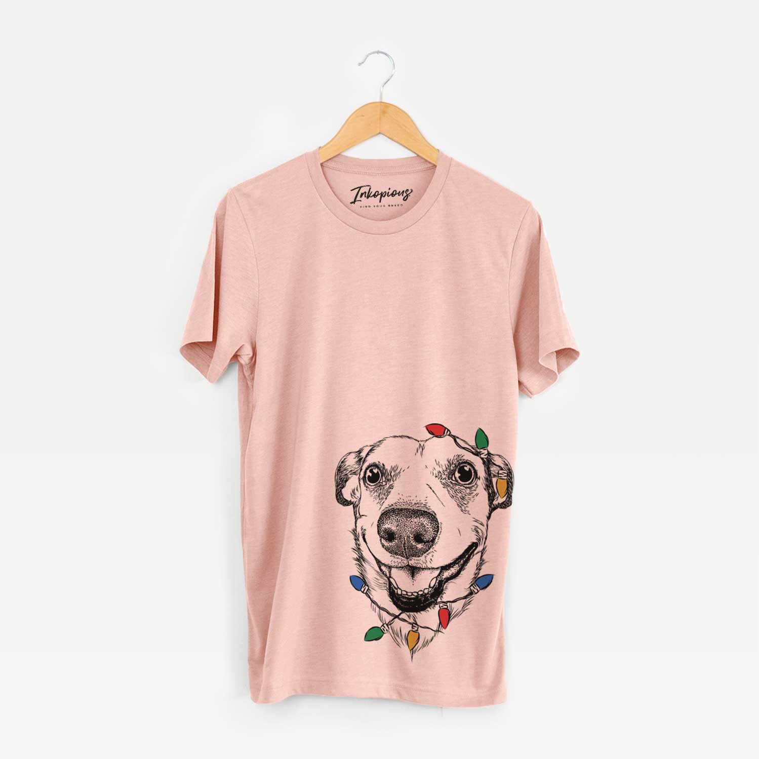 Hand-drawn sketch of Petrah the Staffy Mix wrapped in Christmas lights on a Peach Unisex crewneck