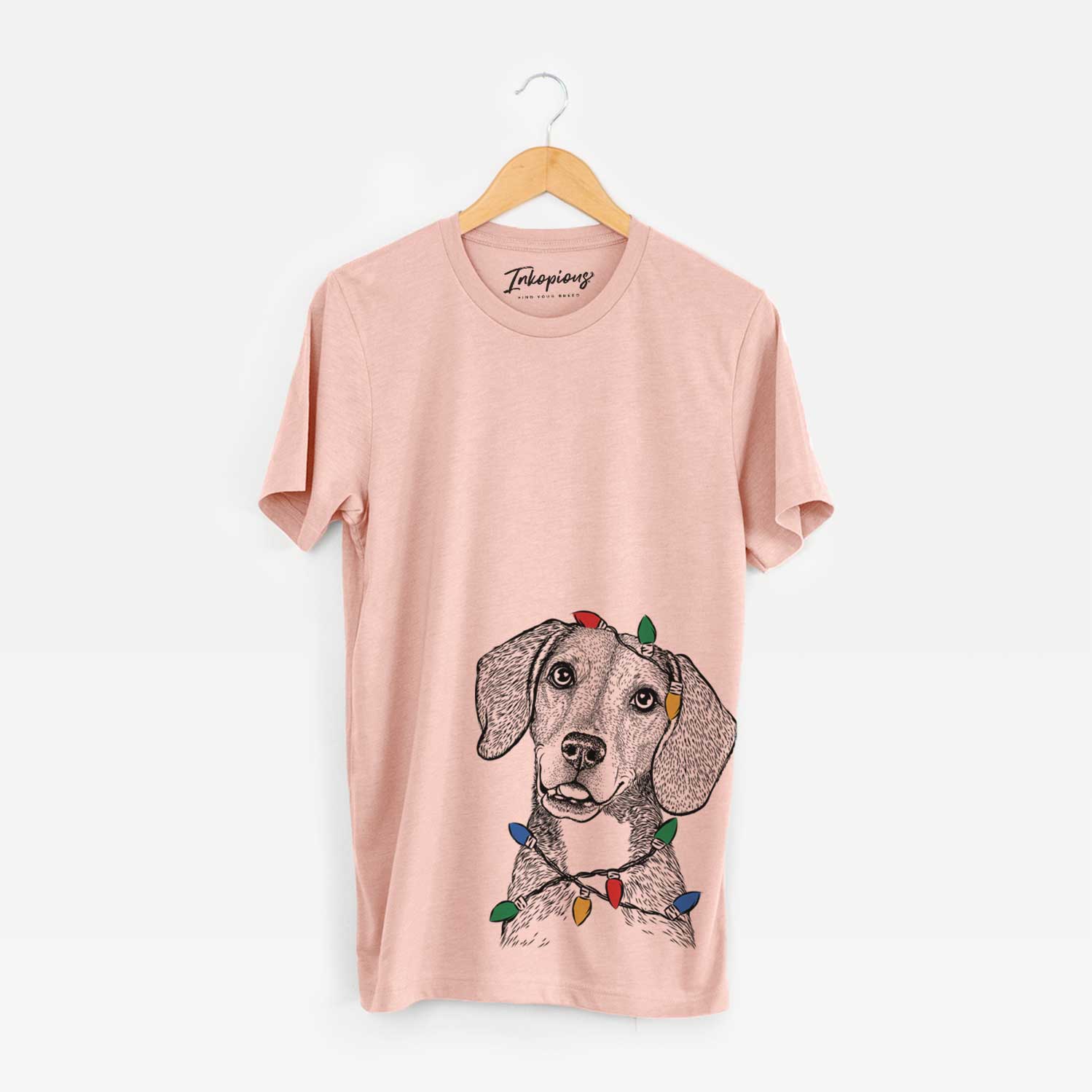 Hand-drawn sketch of Piggy the Beagle Mix wrapped in Christmas lights on a Peach Unisex crewneck