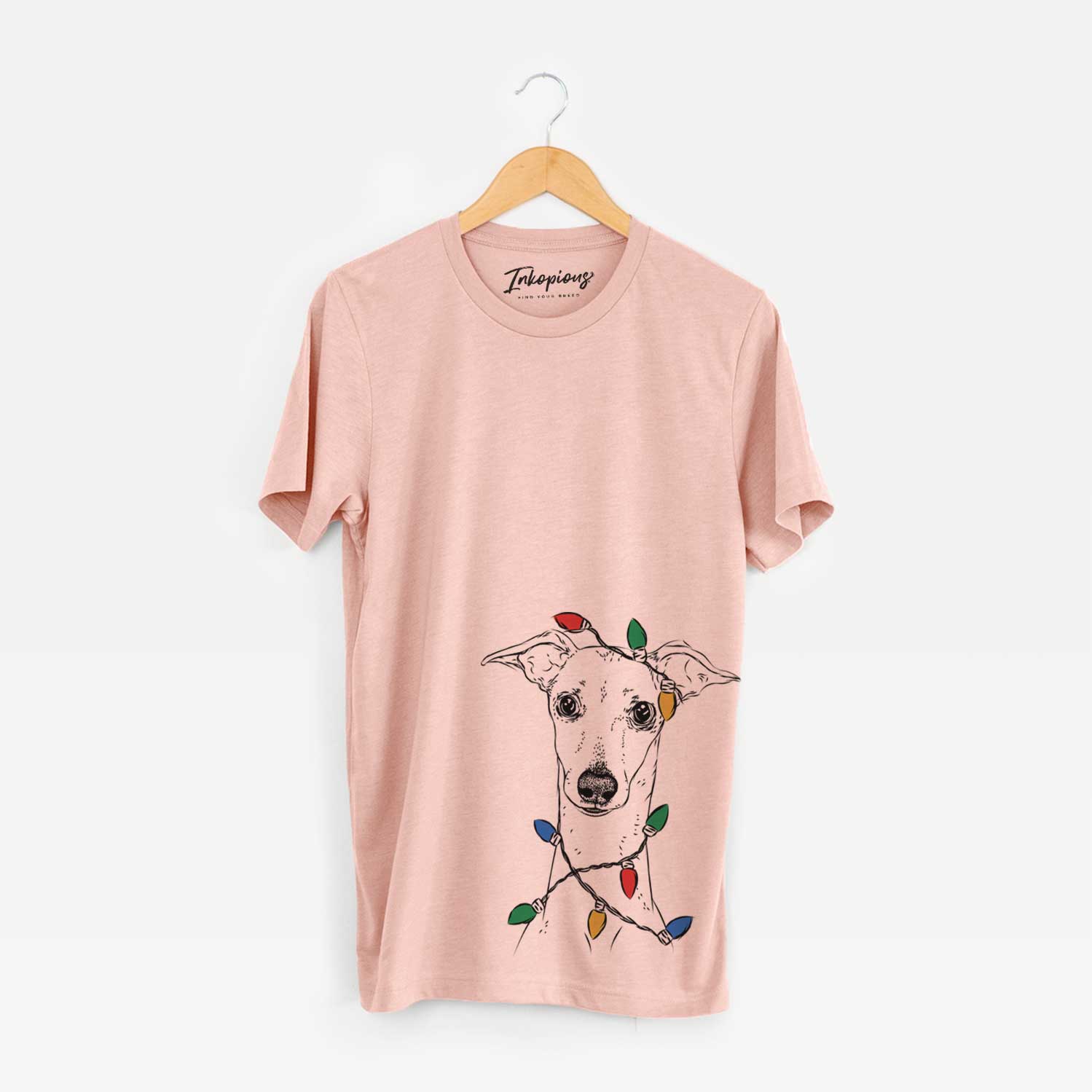 Hand-drawn sketch of Pip the Italian Greyhound wrapped in Christmas lights on a Peach Unisex crewneck