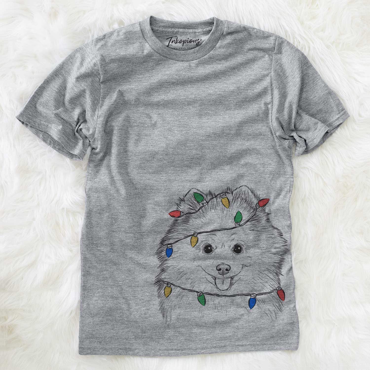 Hand-drawn sketch of Piper Jo the Pomeranian wrapped in Christmas lights on a Grey Unisex crewneck
