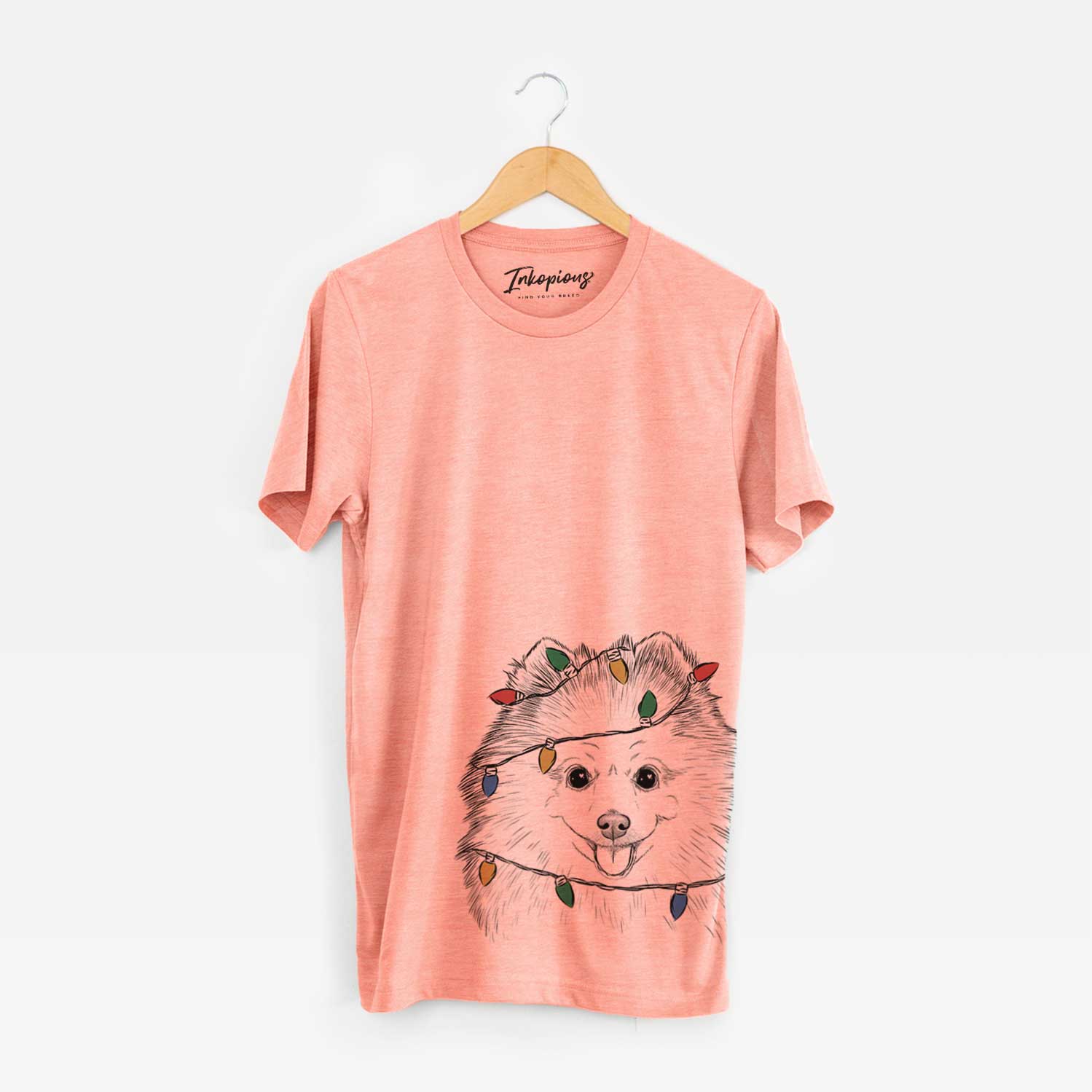 Hand-drawn sketch of Piper Jo the Pomeranian wrapped in Christmas lights on a Sunset Unisex crewneck