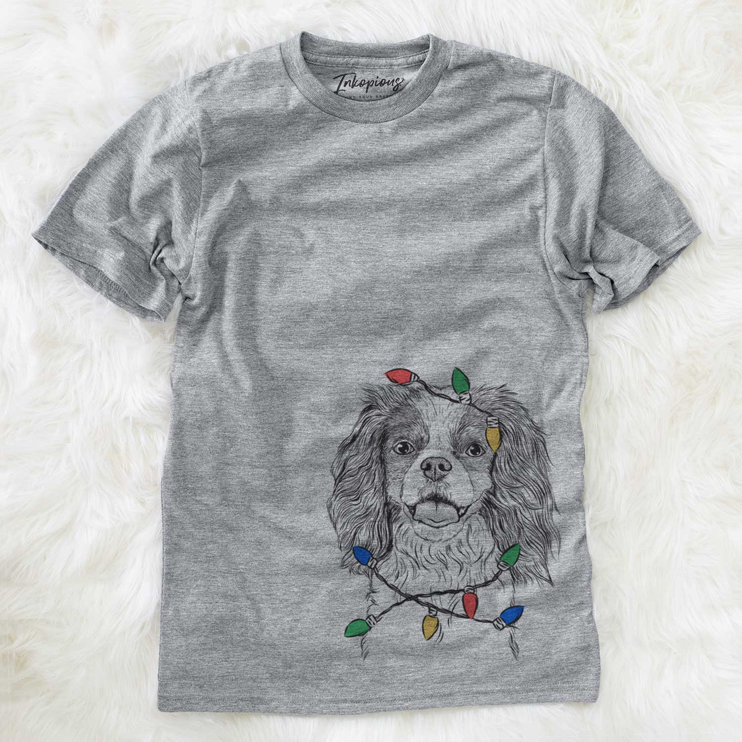 Hand-drawn sketch of Poppy the Cavalier King Charles Spaniel wrapped in Christmas lights on a Grey Unisex crewneck