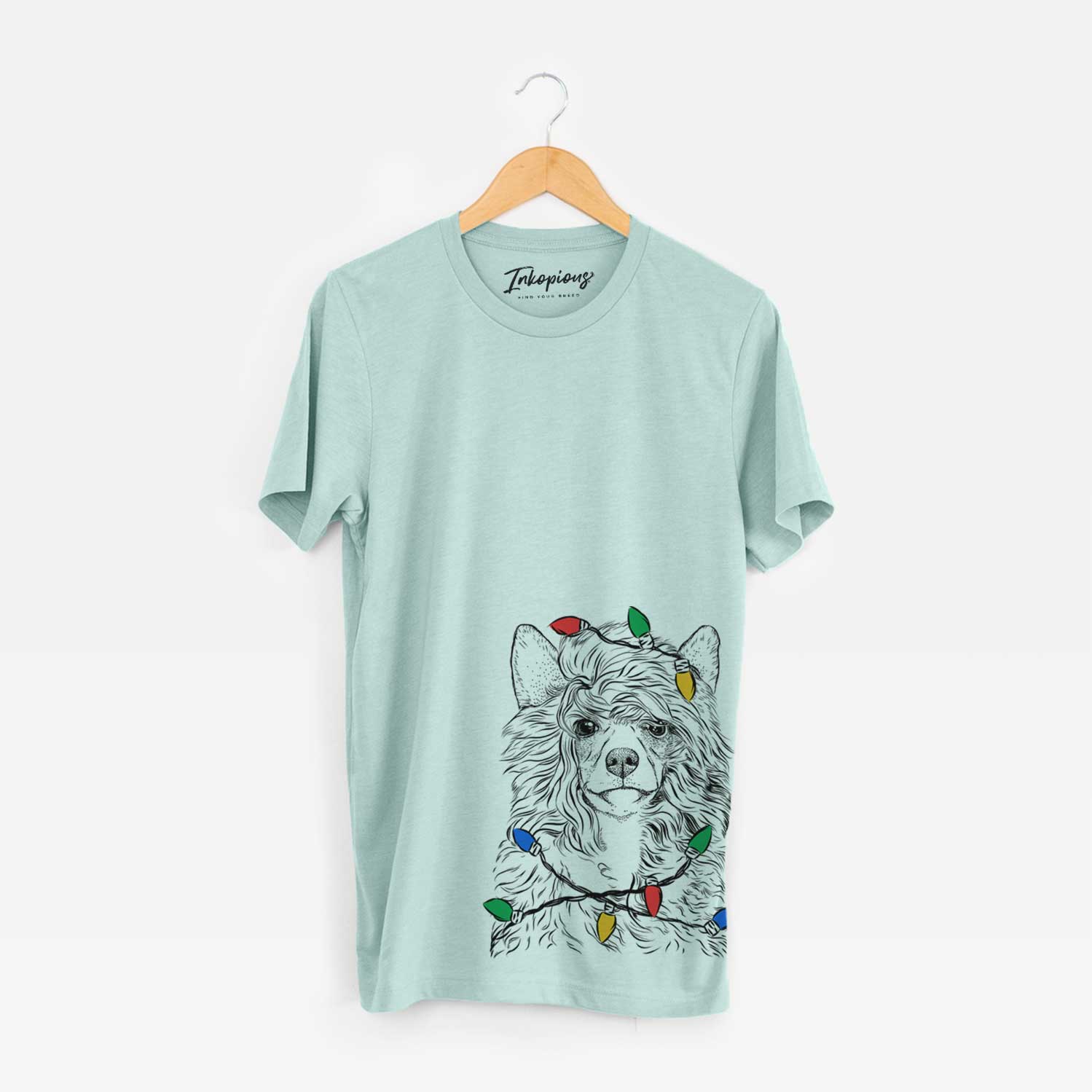 Hand-drawn sketch of Preston the Powderpuff Chinese Crested wrapped in Christmas lights on a Heather Sage Unisex crewneck